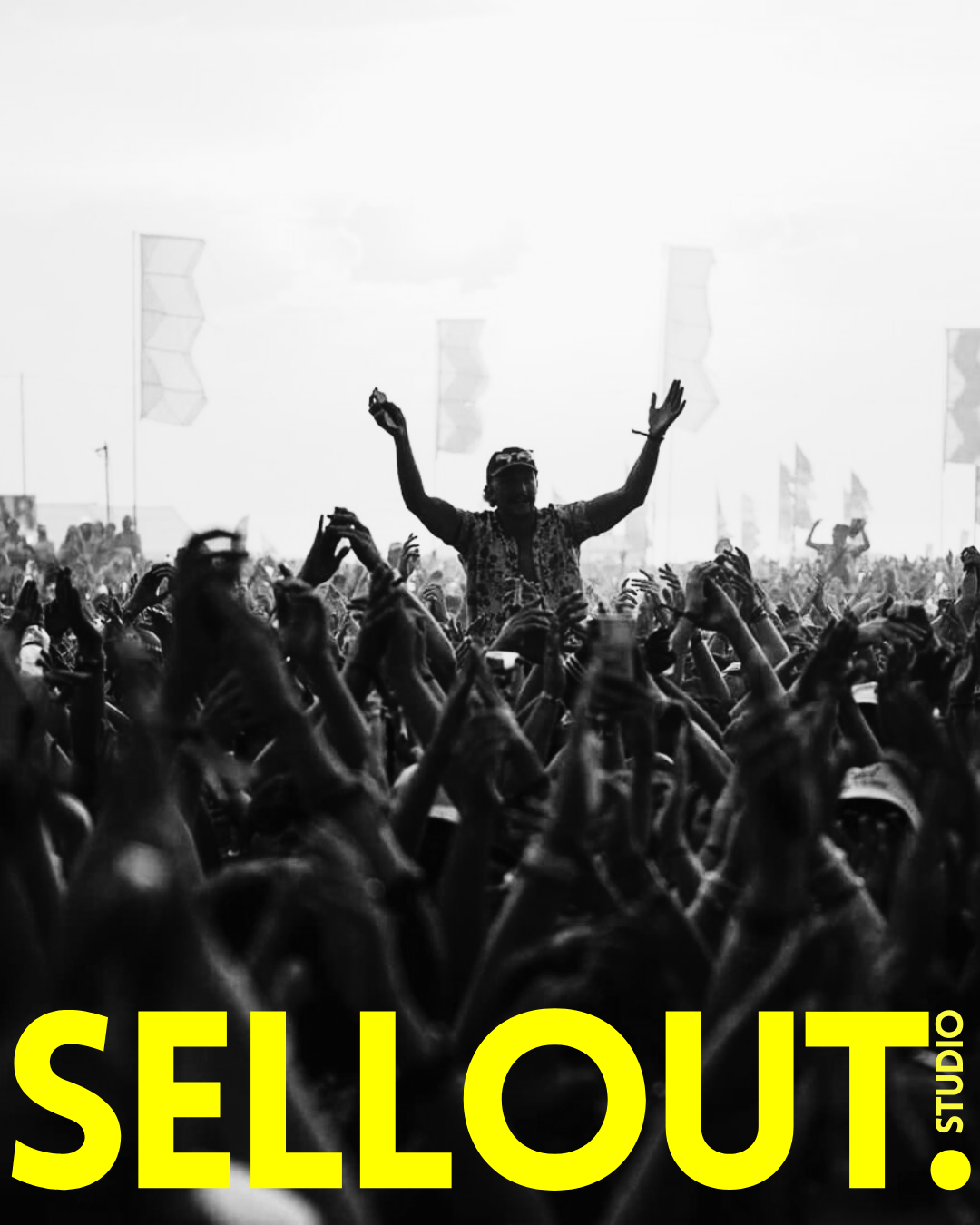 A black and white photo of a large crowd at a concert or festival, with one person standing elevated above others, raising arms in celebration. The text "SELLOUT" is prominently displayed in bold yellow letters at the bottom, with a smaller