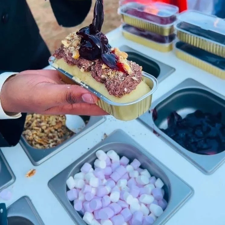 Build-your-own cake bar with frosting, toppings, candies, cookies, and mini cake decorating station for birthday parties near Sherman Texas.