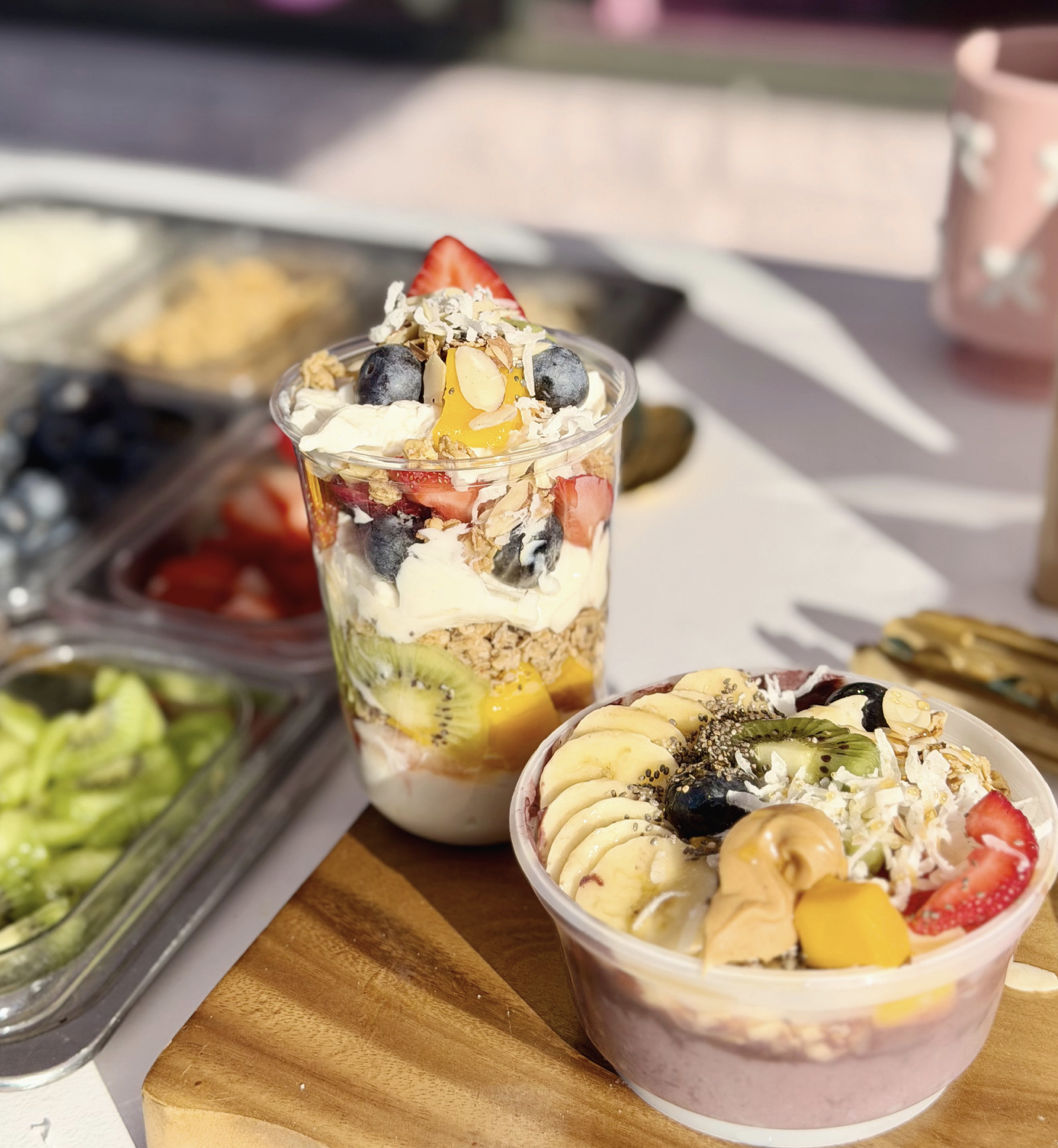Parfait bar setup with yogurt, granola, fresh fruit, cereals, syrups, and toppings for brunch parties and baby showers in DFW.