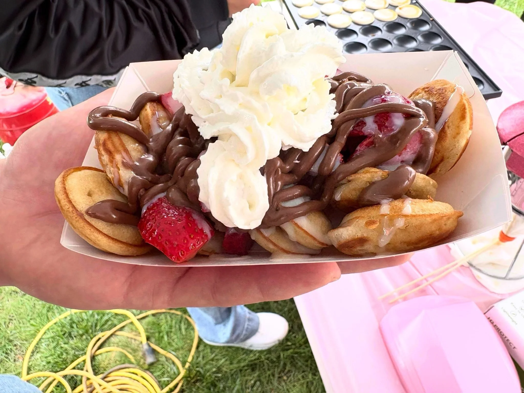 Build-your-own mini pancake bar with toppings, fruit, syrups, whipped cream, and cereals at a mobile event cart service in North Texas.