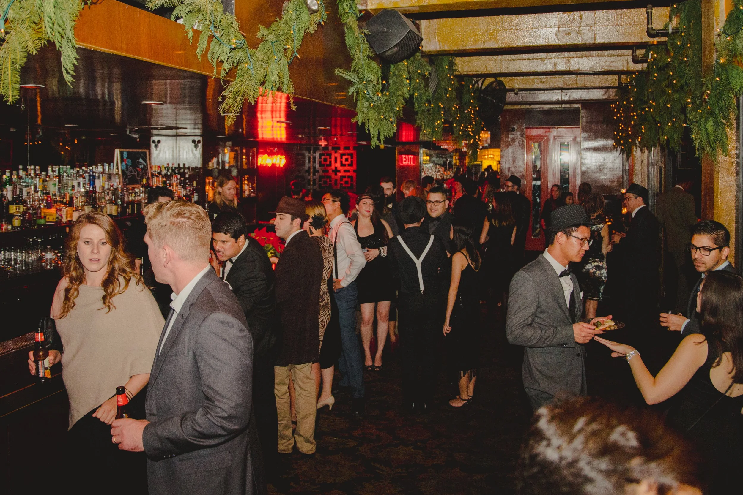 people gathering at a christmas company holiday party at a speakeasy in downtown Los Angeles