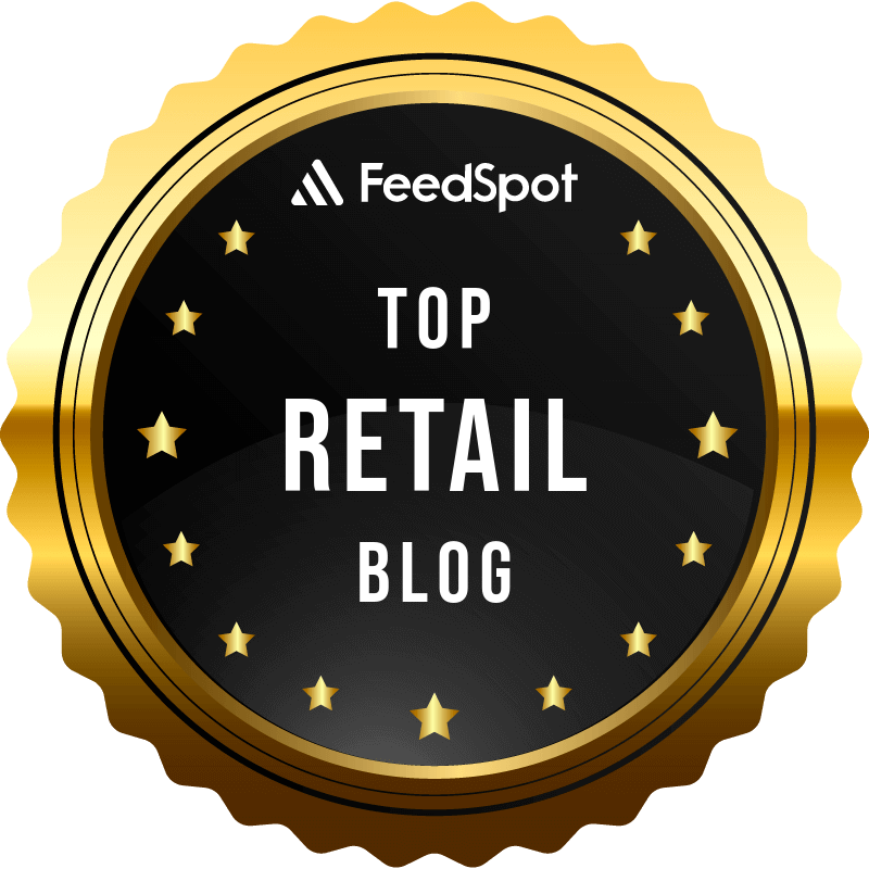 Gold and black medal or badge with the text "FeedSpot Top Retail Blog" and small gold stars around the border.