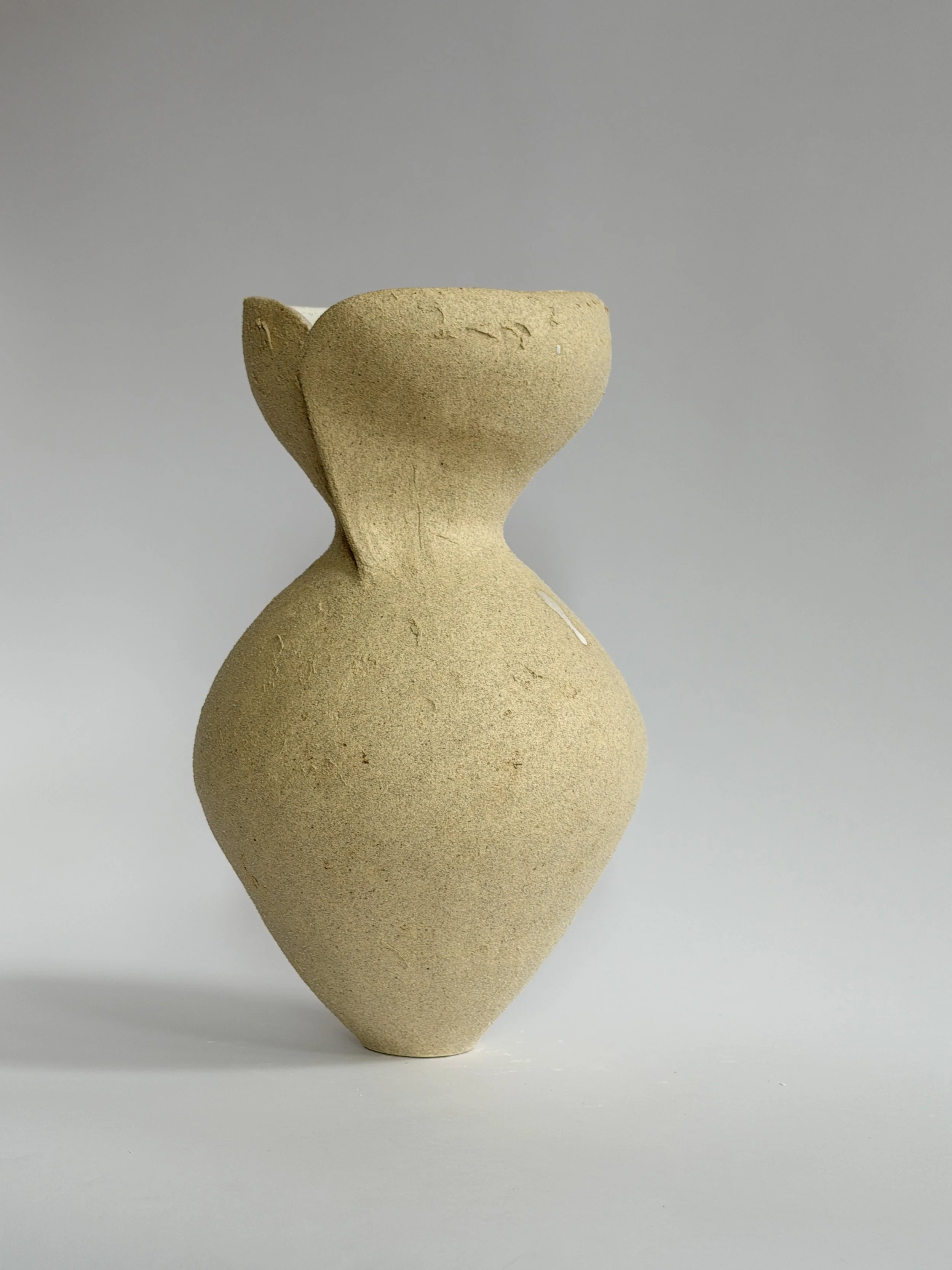Silhouette Vase in Beige by Anastasia Babenko — tracing a woman's full, rounded silhouette in beige stoneware, original ceramic art for