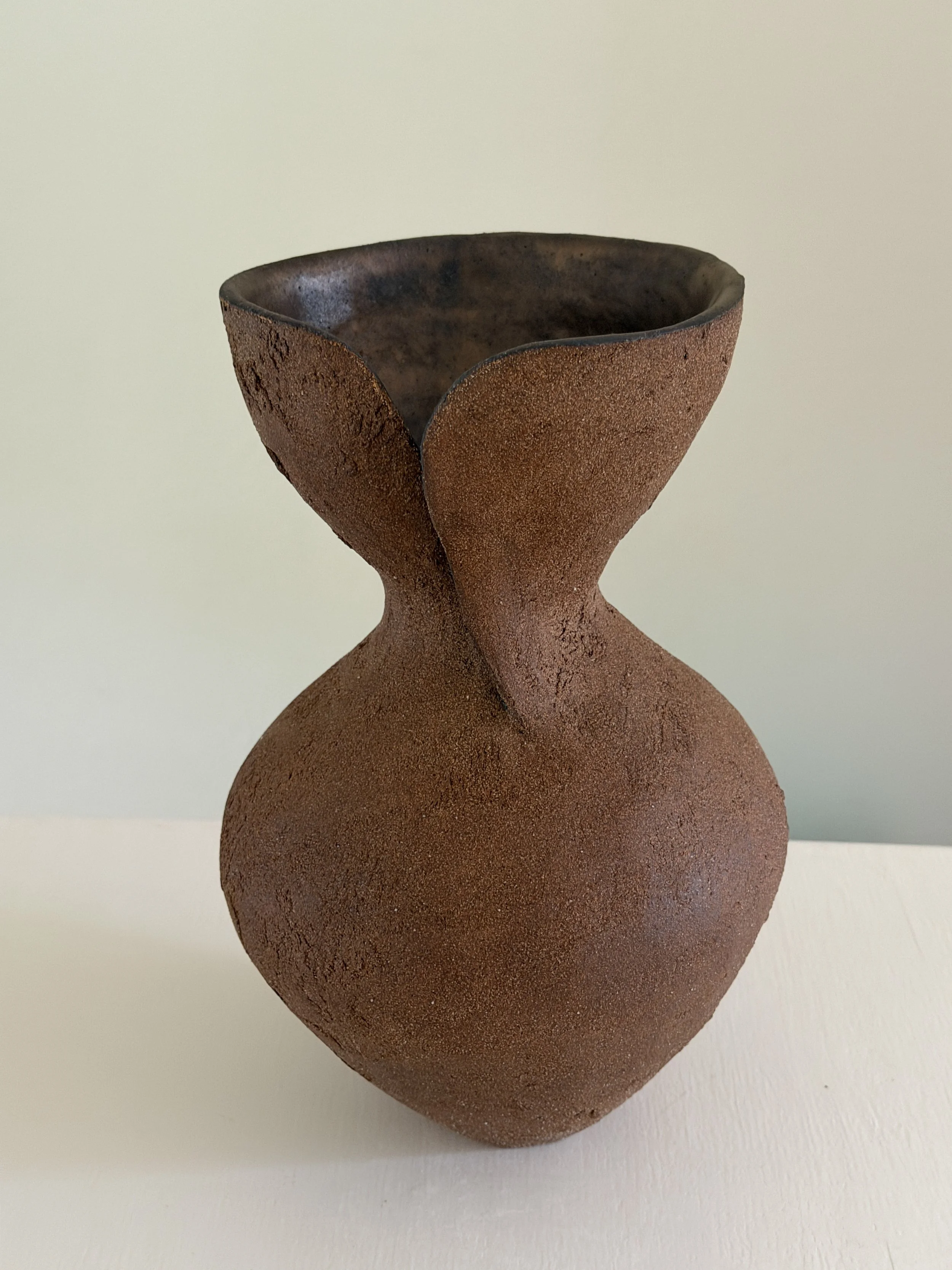 Hand-built ceramic vase: Silhouette Vase in Brown, tracing a woman's full, rounded silhouette in warm brown stoneware — Anastasia Babenko