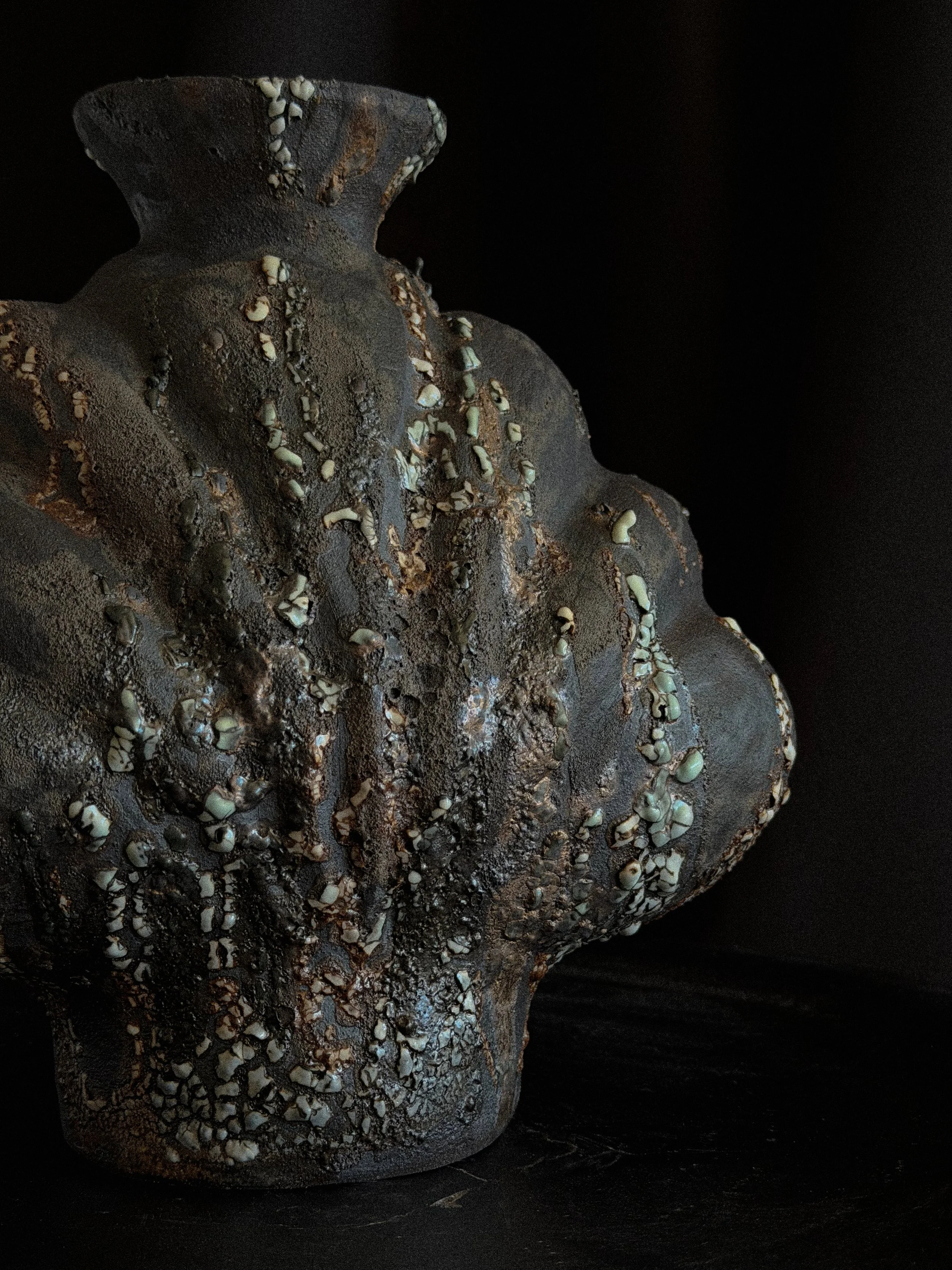 Hand-built ceramic vase: Shell in Black, with heavy scalloped ridges and a dark, stony matte finish — Anastasia Babenko