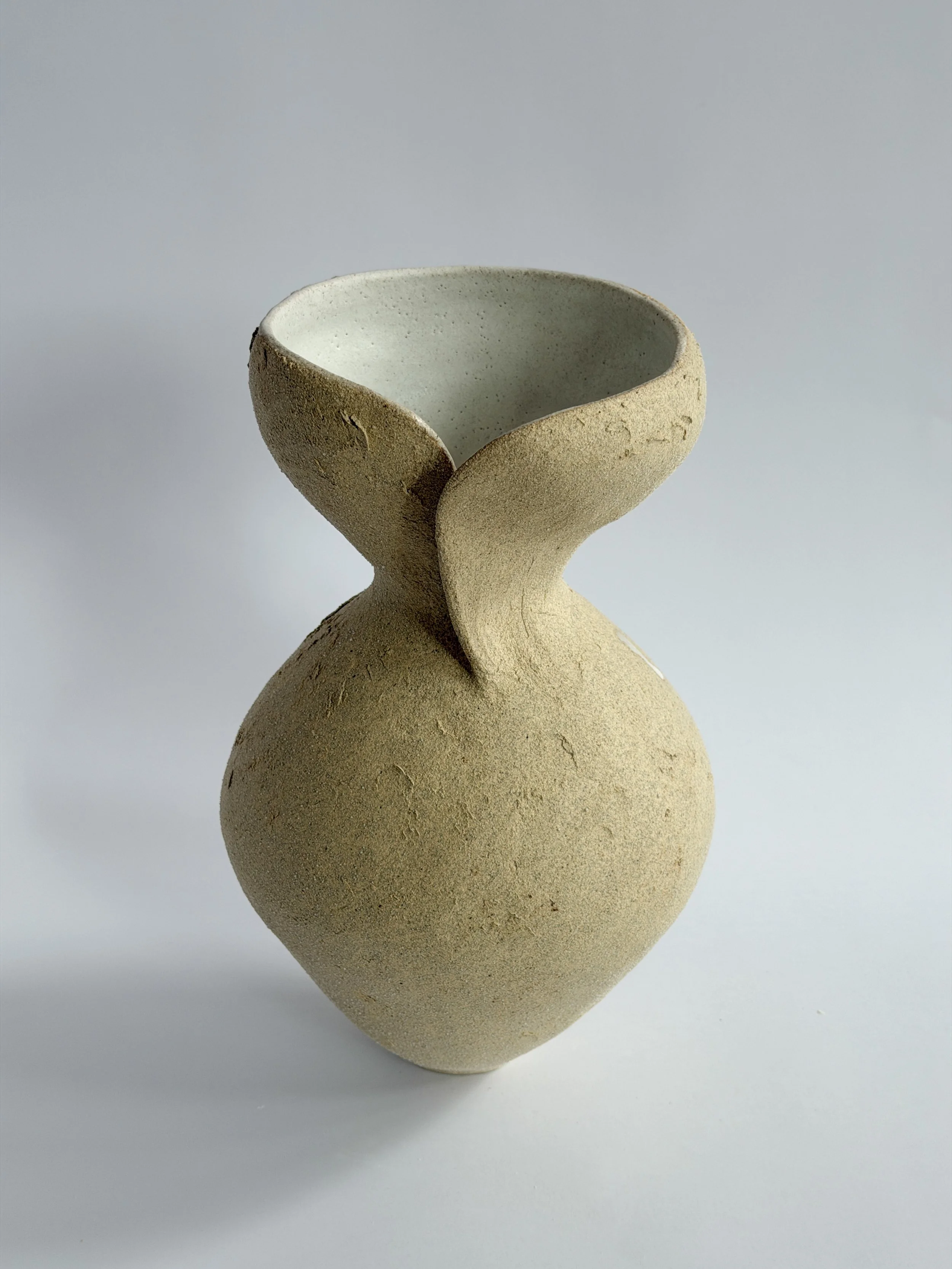 Silhouette Vase in Beige: tracing a woman's full, rounded silhouette in beige stoneware, a sculptural ceramic vase by Anastasia Babenko