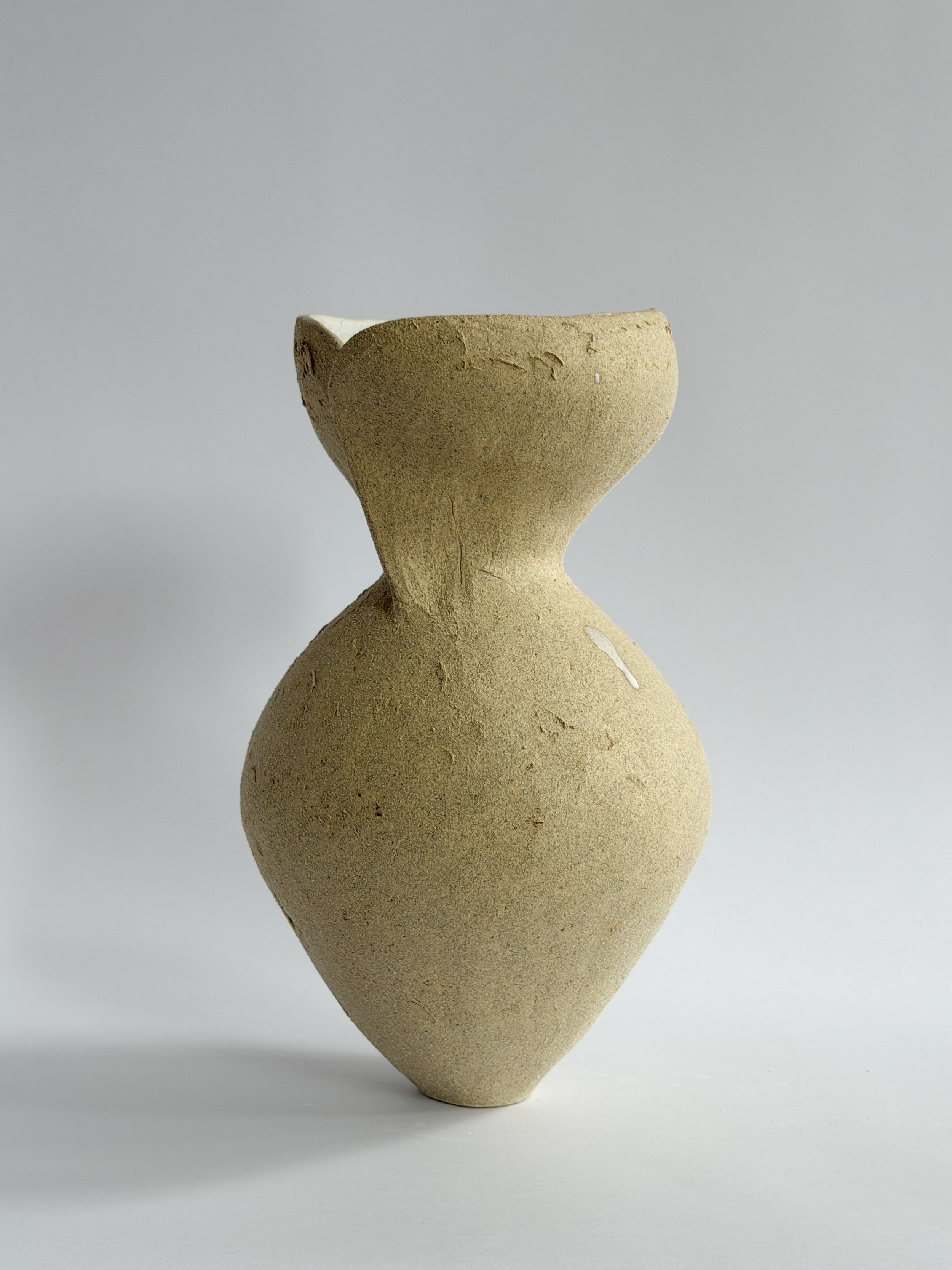 Hand-built ceramic vase: Silhouette Vase in Beige, tracing a woman's full, rounded silhouette in beige stoneware — Anastasia Babenko
