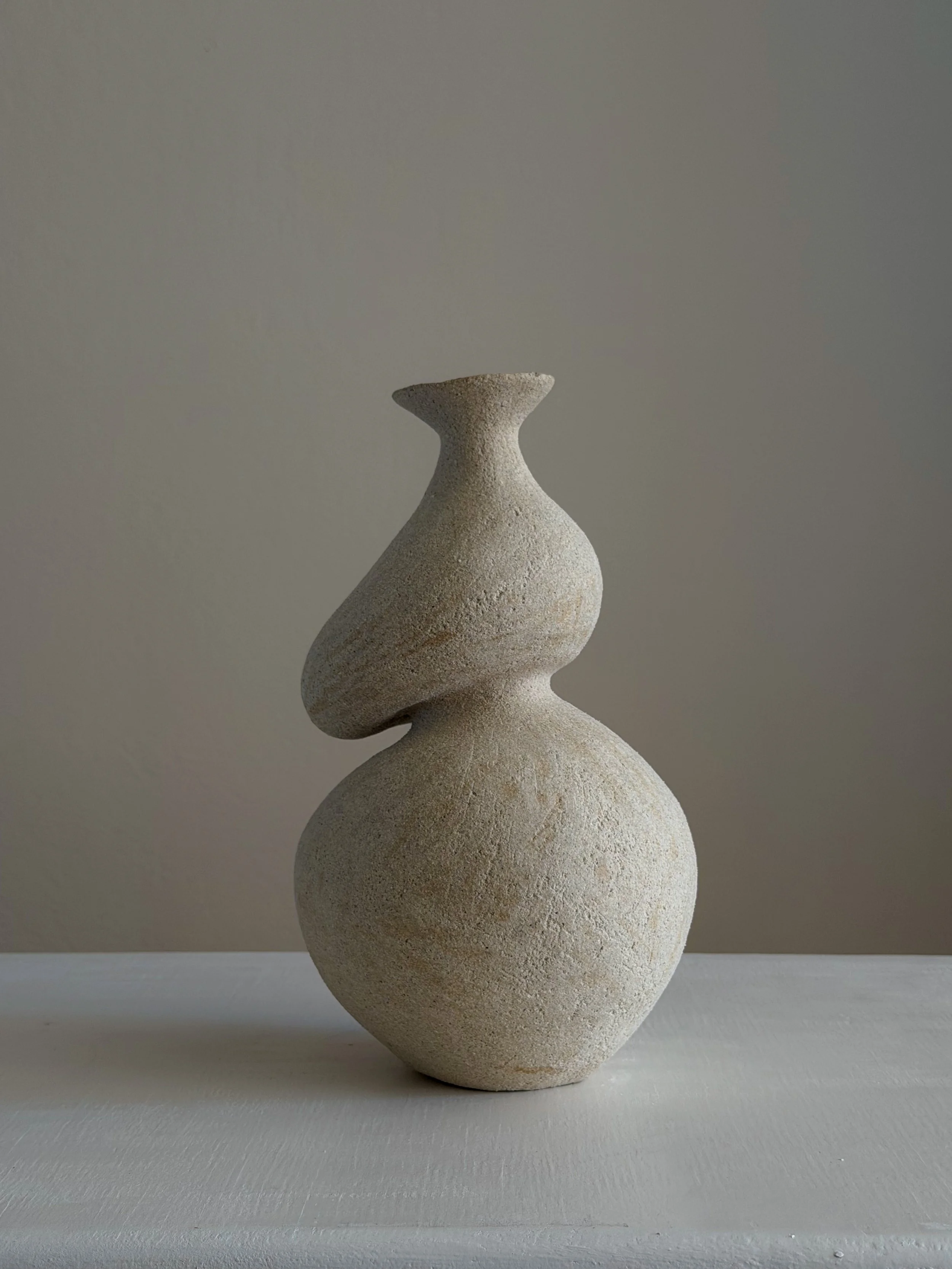She 5 — hand-built ceramic vase in the form of a woman caught mid-turn, tilting toward a slender neck, by Anastasia Babenko