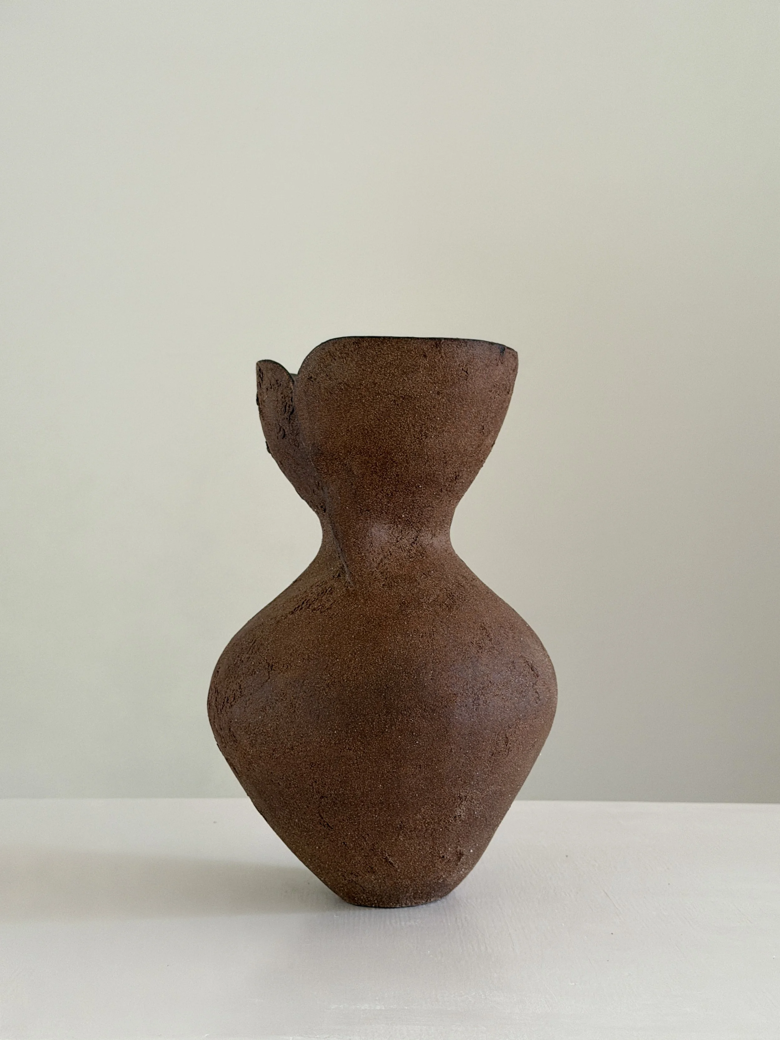 Silhouette Vase in Brown, tracing a woman's full, rounded silhouette in warm brown stoneware — sculptural ceramic vase sculptural decor for