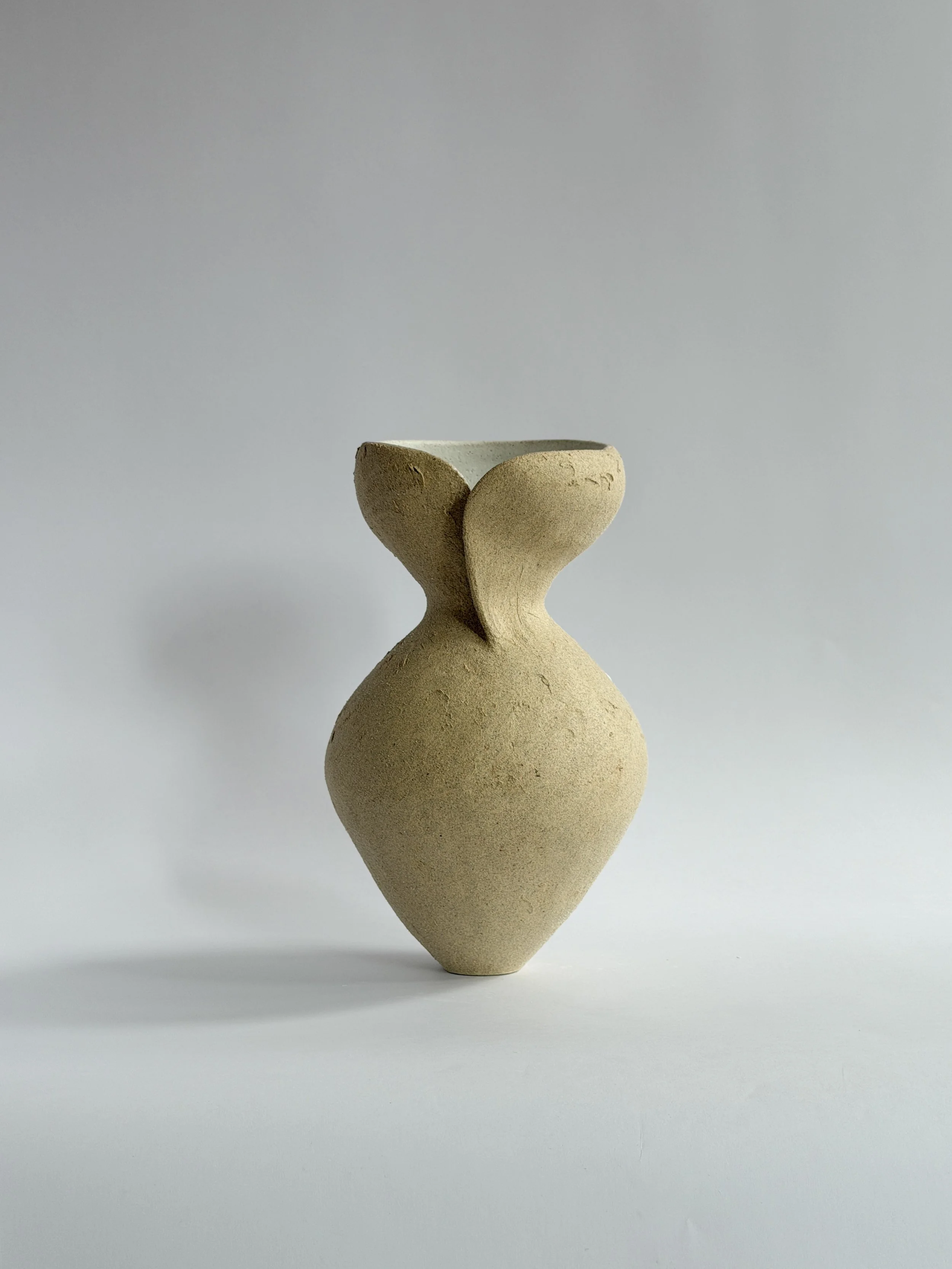 Silhouette Vase in Beige — hand-built ceramic vase tracing a woman's full, rounded silhouette in beige stoneware, by Anastasia Babenko