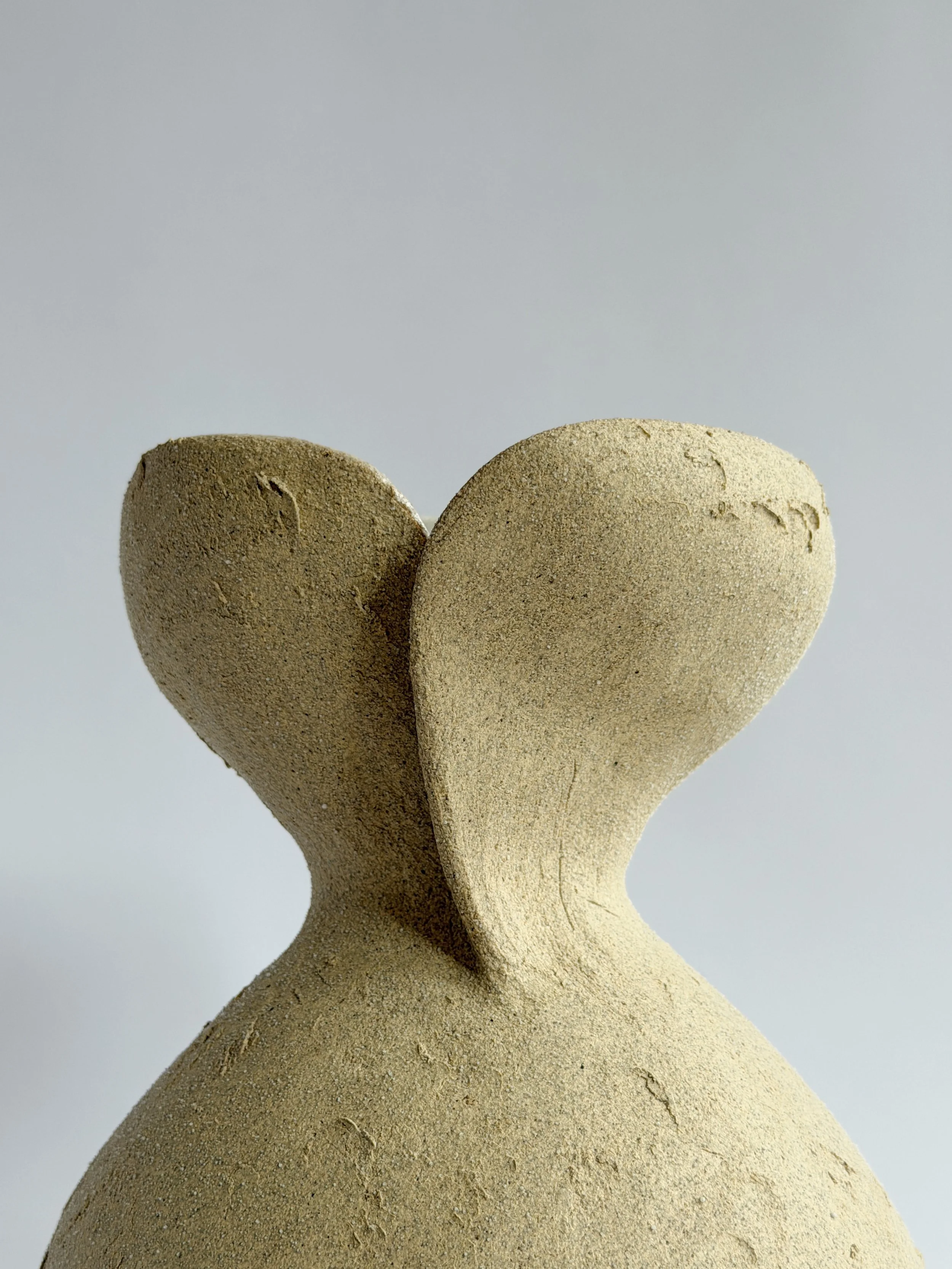 Silhouette Vase in Beige — hand-built ceramic vase tracing a woman's full, rounded silhouette in beige stoneware, by Anastasia Babenko