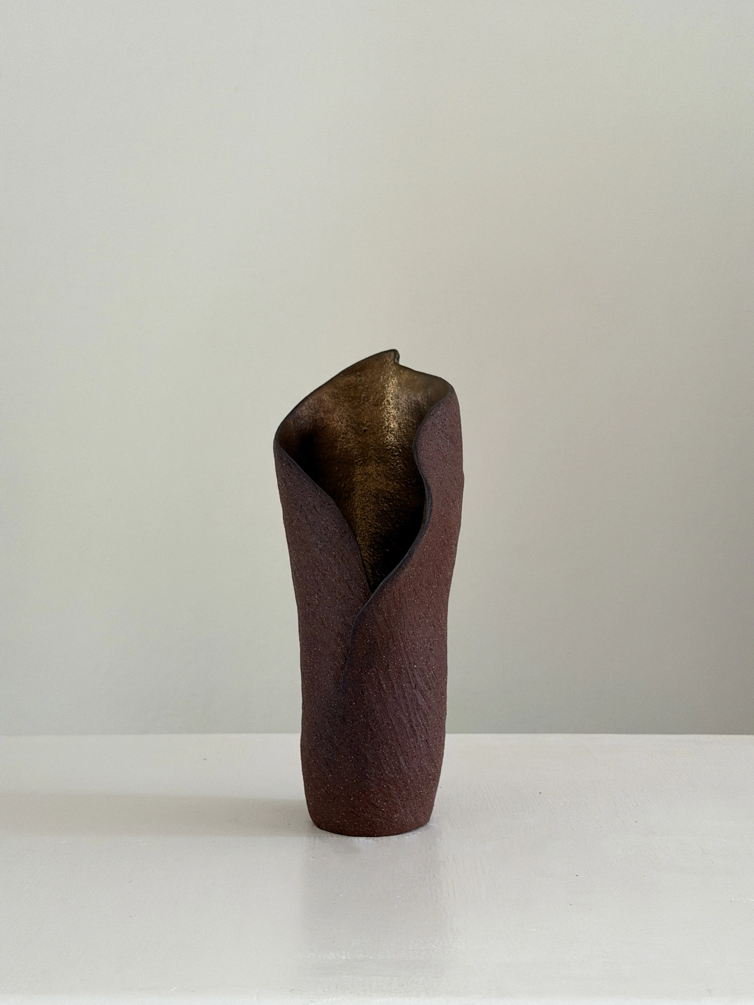 Calla 8 — hand-built ceramic vase drawn from the calla lily, soft and slightly twisted, in beige stoneware, by Anastasia Babenko