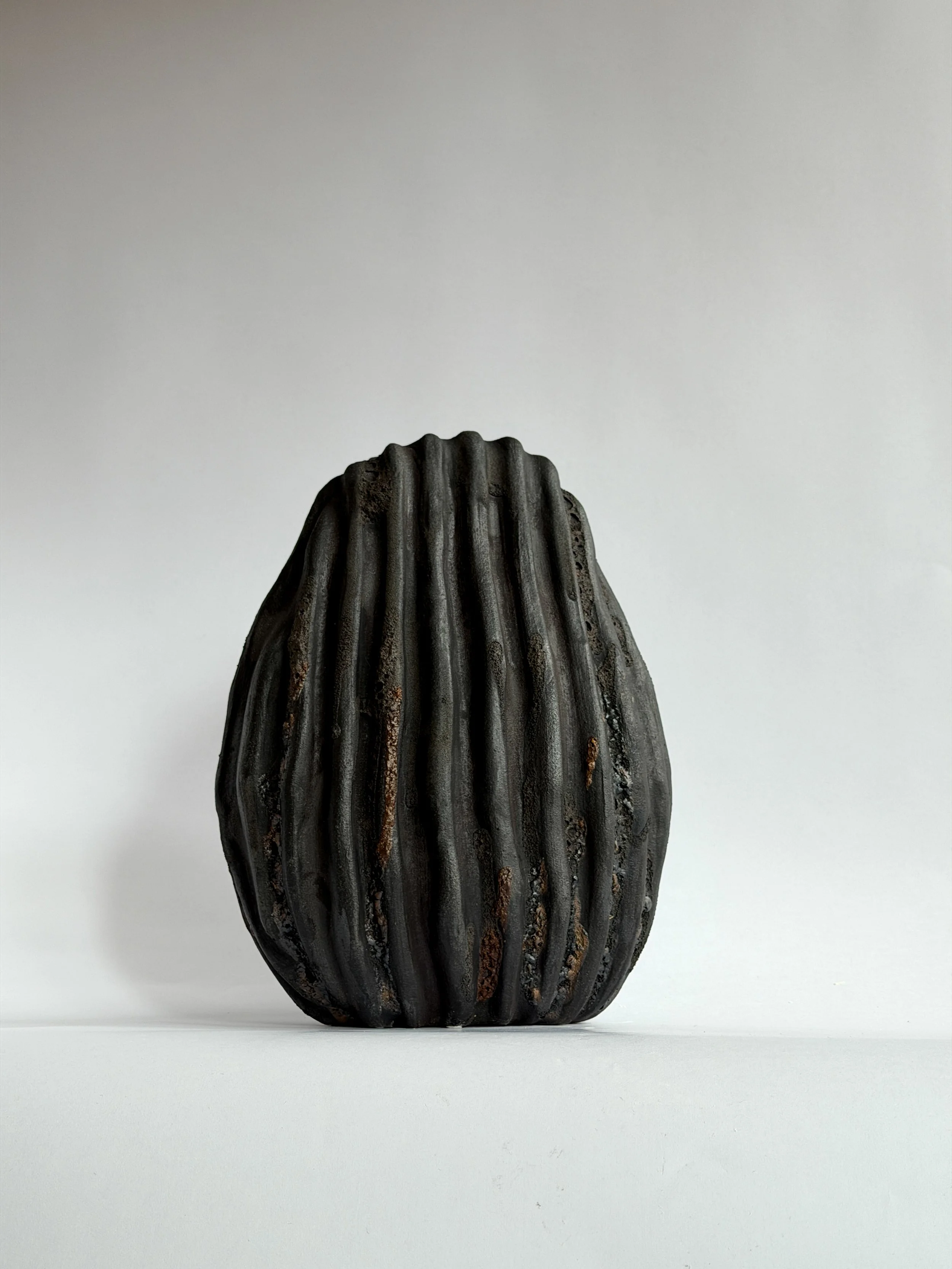 Large Black Shell Vase by Anastasia Babenko — shaped like a large deep-sea shell with heavy scalloped ridges in dark stoneware, original