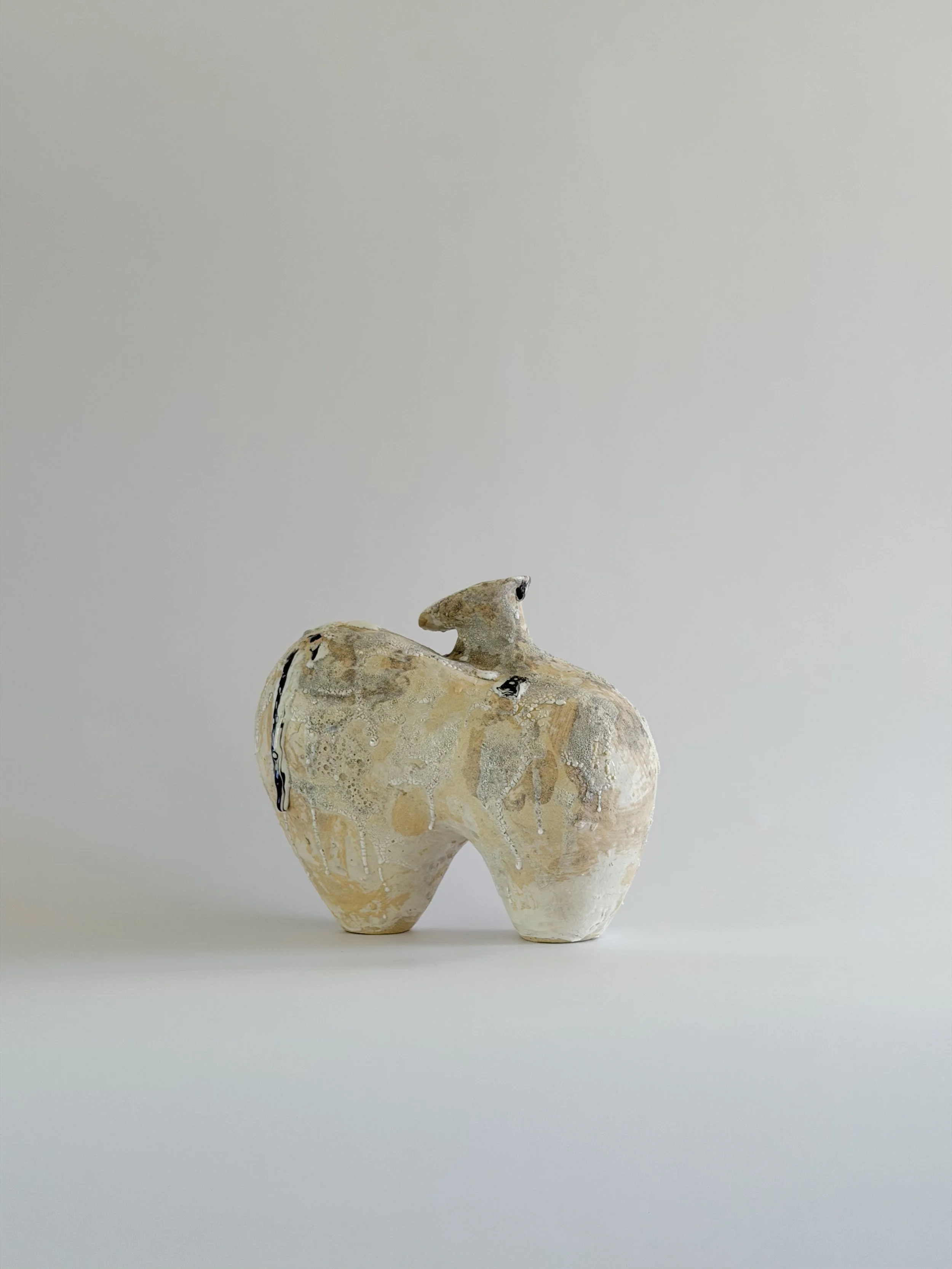Form No. 1: with two full volumes resting under a crawling, sand-colored mineral crust, a sculptural ceramic vase by Anastasia Babenko