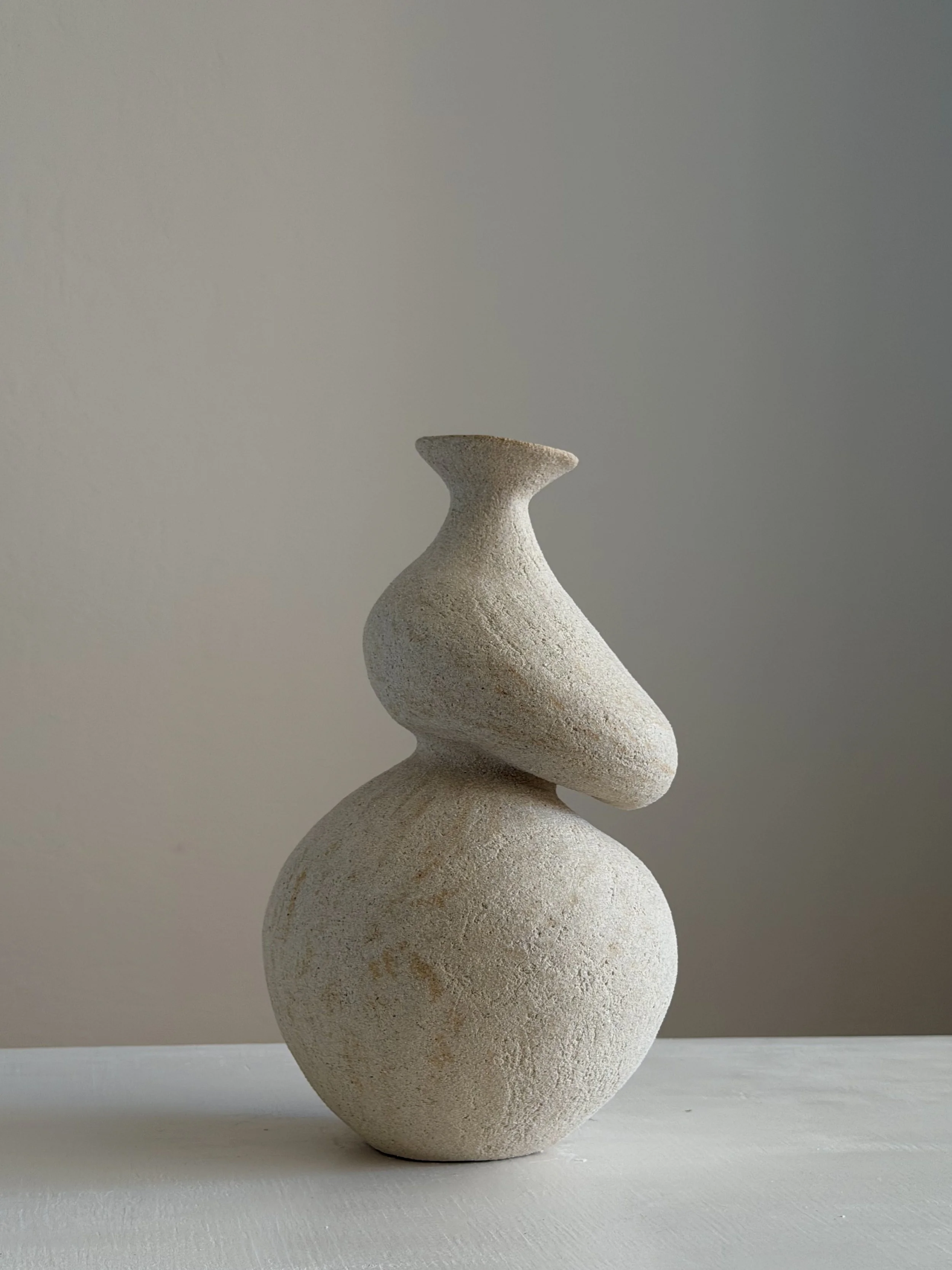 She 5 — hand-built ceramic vase in the form of a woman caught mid-turn, tilting toward a slender neck, by Anastasia Babenko