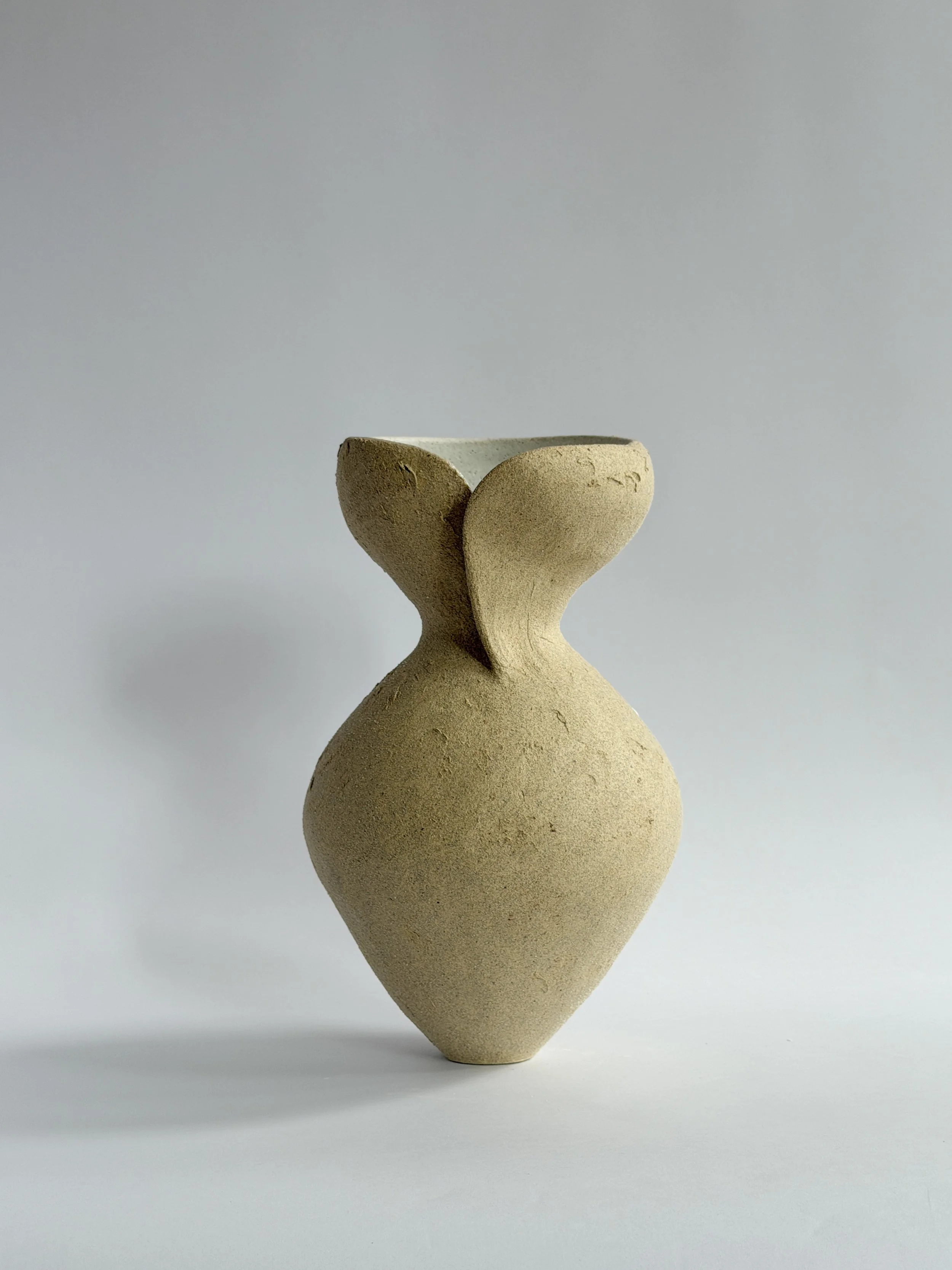 Silhouette Vase in Beige, tracing a woman's full, rounded silhouette in beige stoneware — sculptural ceramic vase sculptural decor for