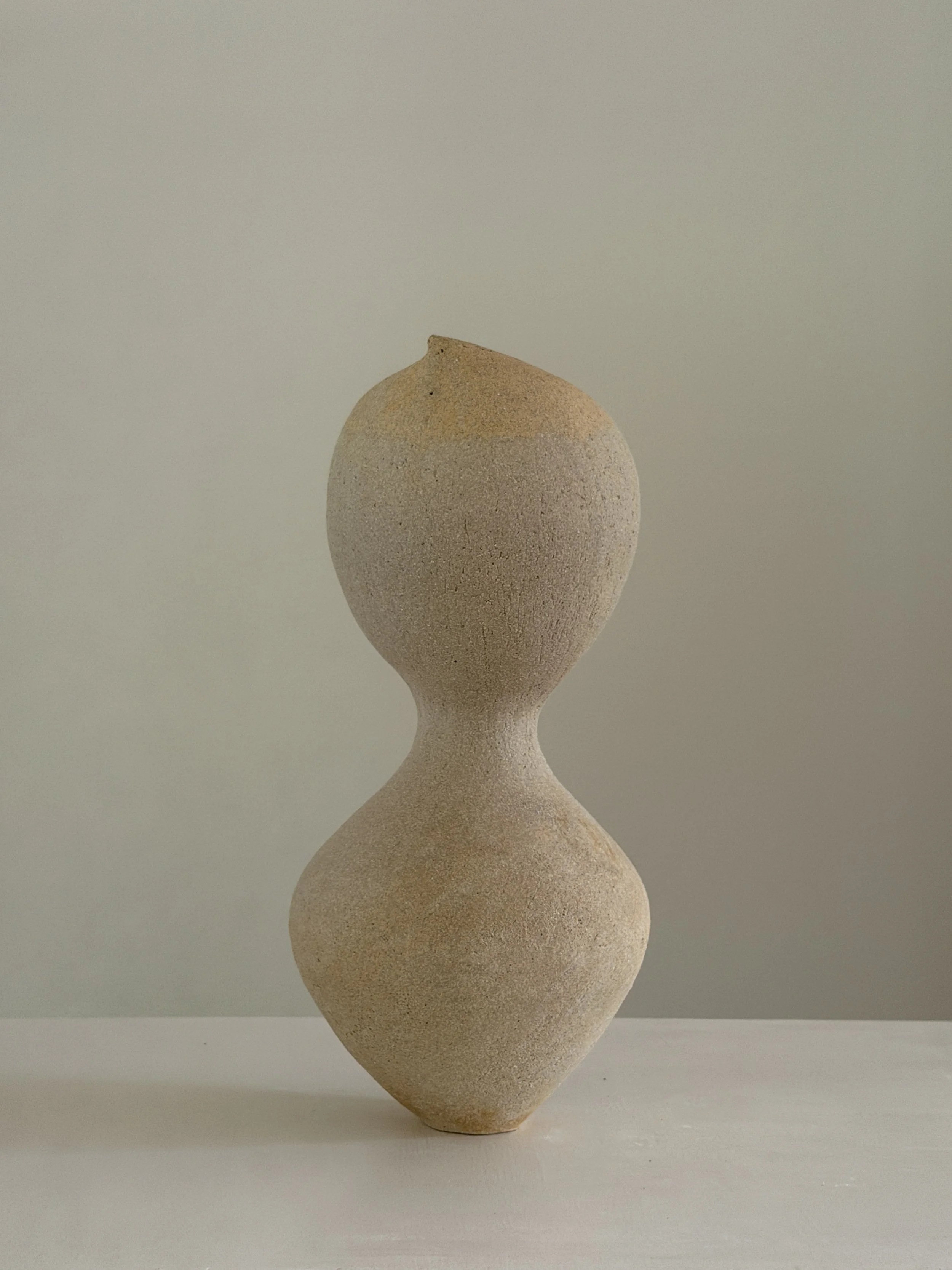 Hand-built ceramic vase: Woman 4, in the form of a woman at rest, soft and full, in warm beige stoneware — Anastasia Babenko