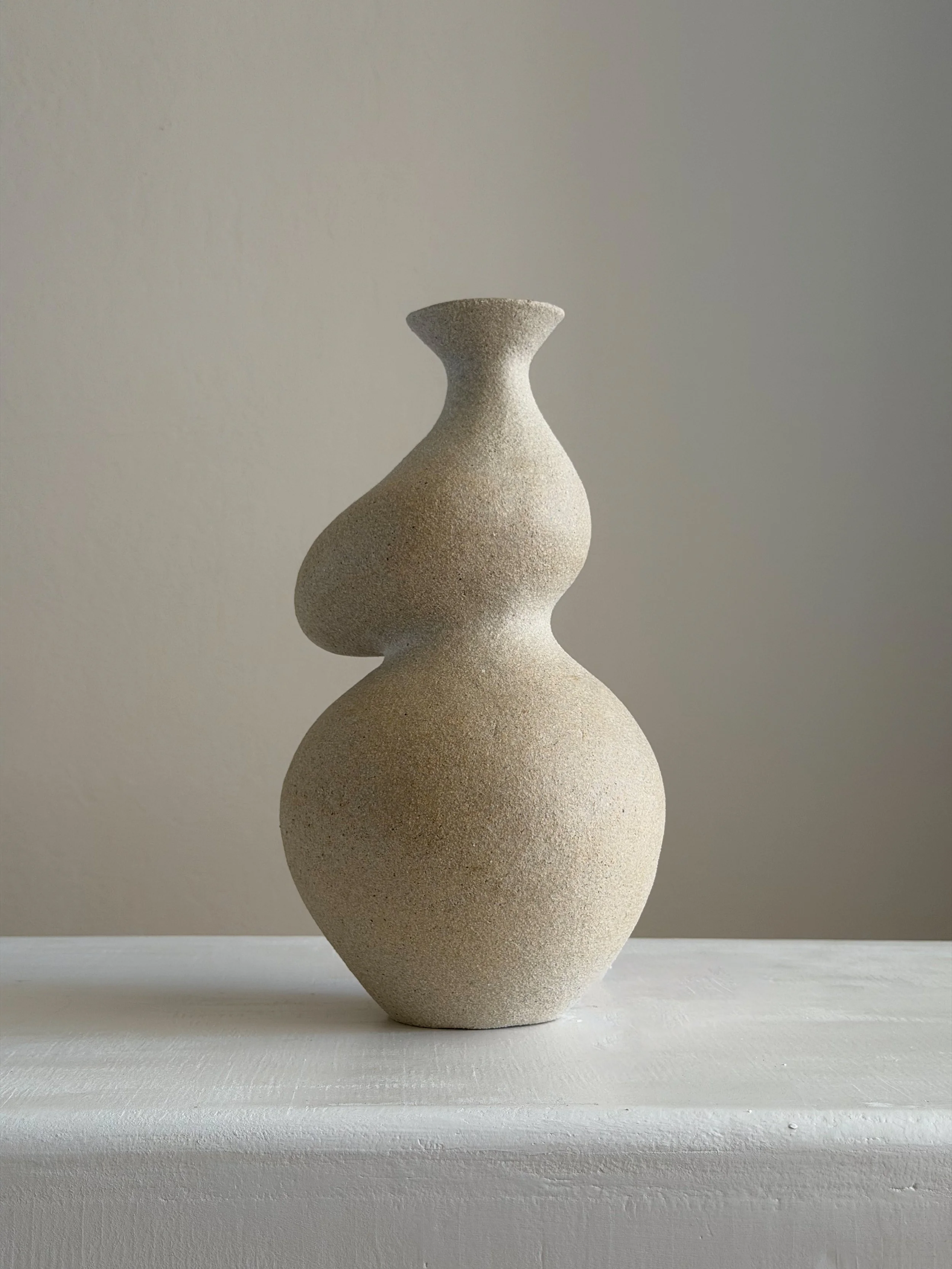 She 4 — hand-built ceramic vase in the form of a woman with a full belly and soft hips shaped from clay, by Anastasia Babenko