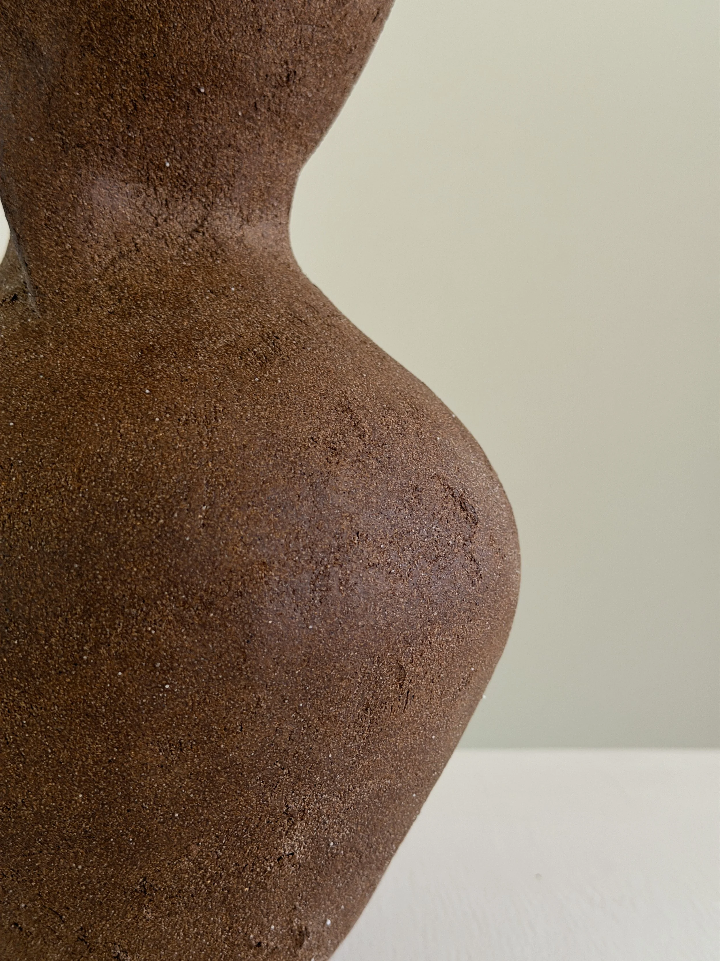 Silhouette Vase in Brown: tracing a woman's full, rounded silhouette in warm brown stoneware, a sculptural ceramic vase by Anastasia Babenko
