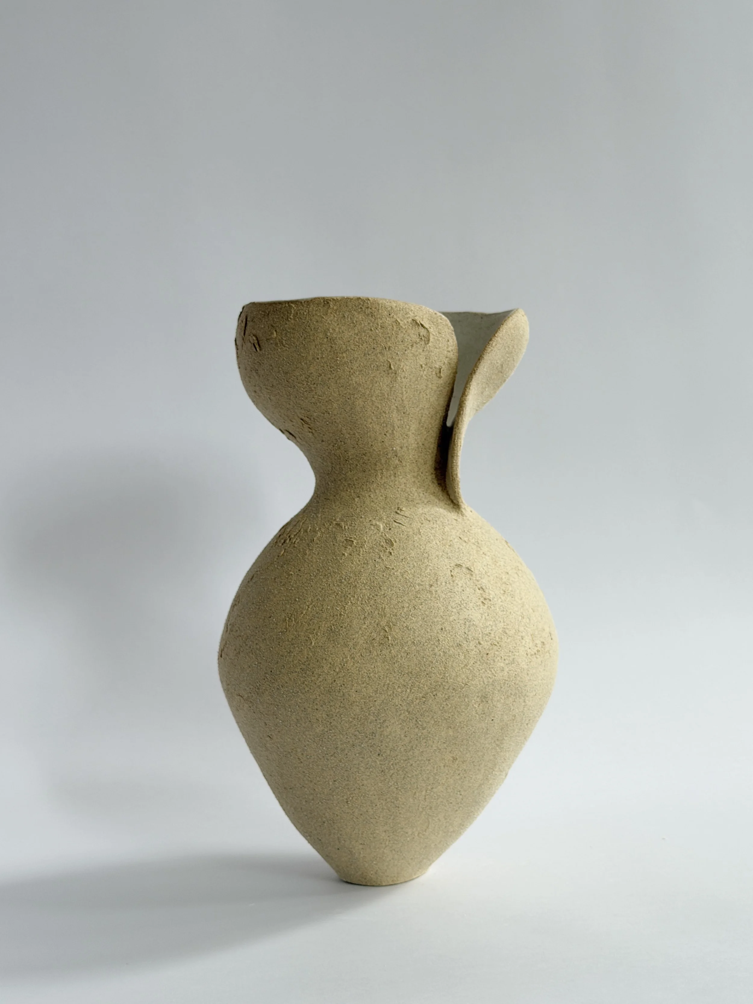 Silhouette Vase in Beige, tracing a woman's full, rounded silhouette in beige stoneware — sculptural ceramic vase made for considered,
