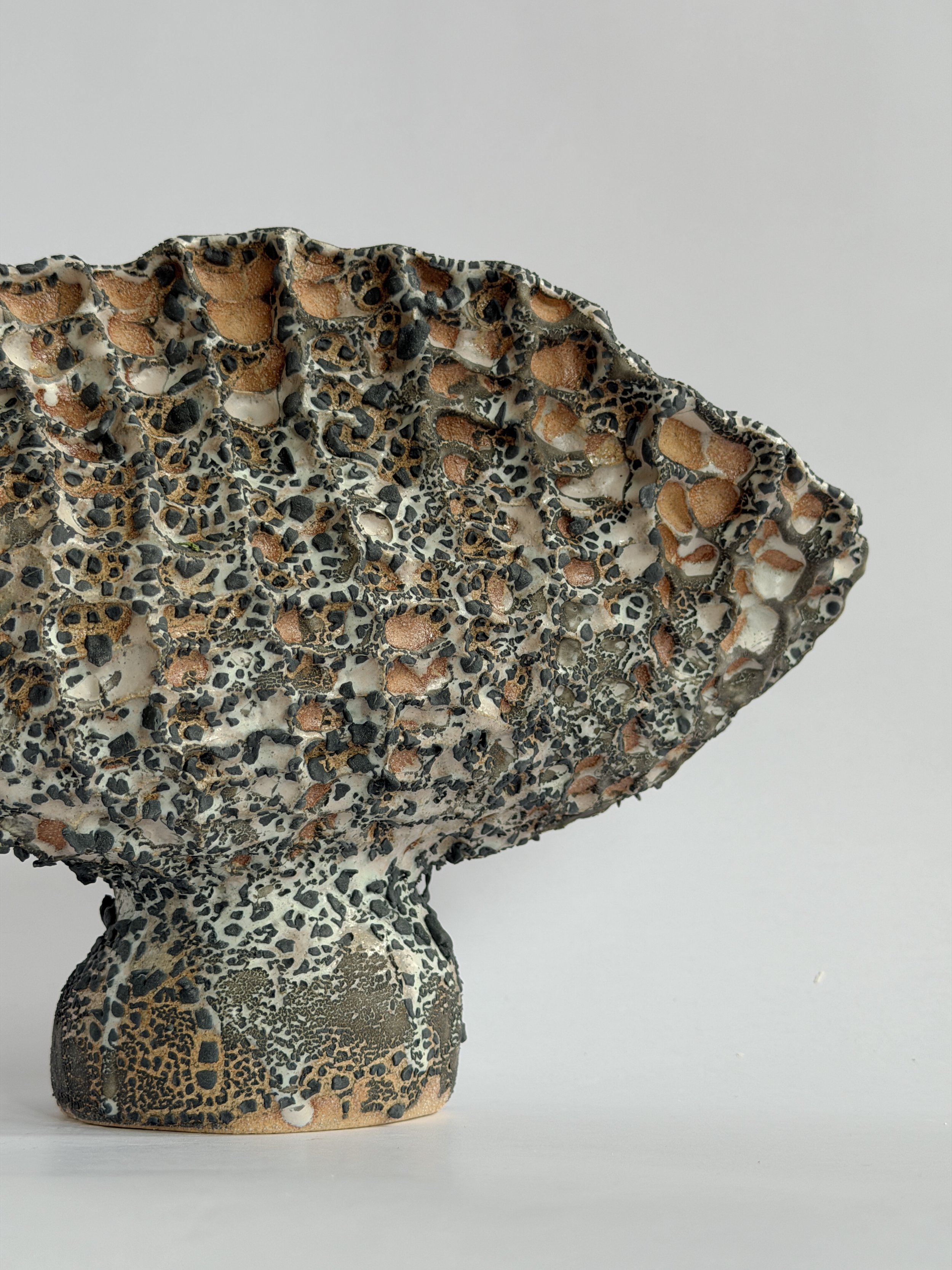 Hand-built ceramic vase: Coral Vase with Black, with a honeycomb, coral-like surface finished in black — Anastasia Babenko