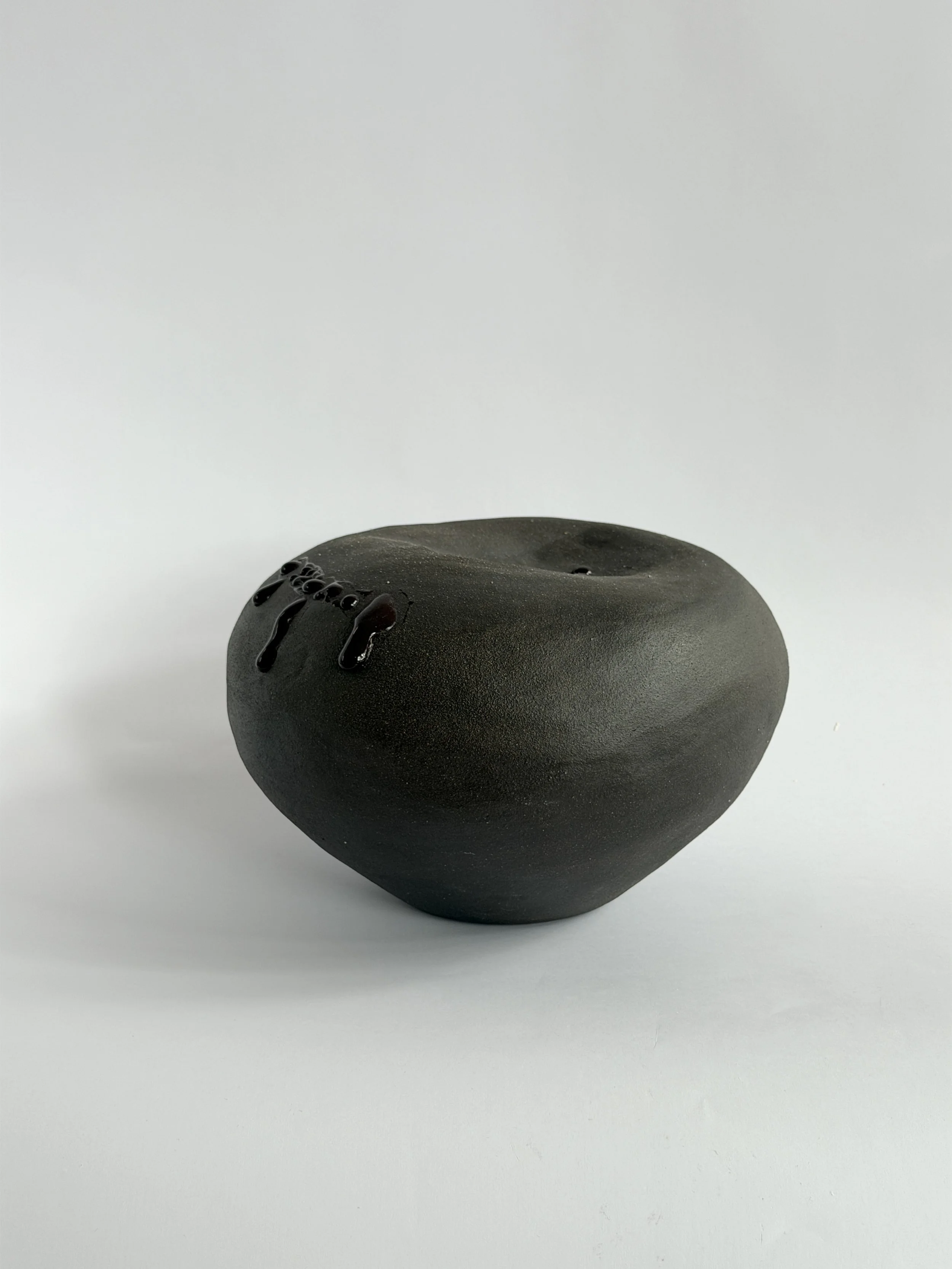 Whispering Stone, shaped like a smooth river stone, organic and calming — sculptural ceramic vase made for considered, organic interiors