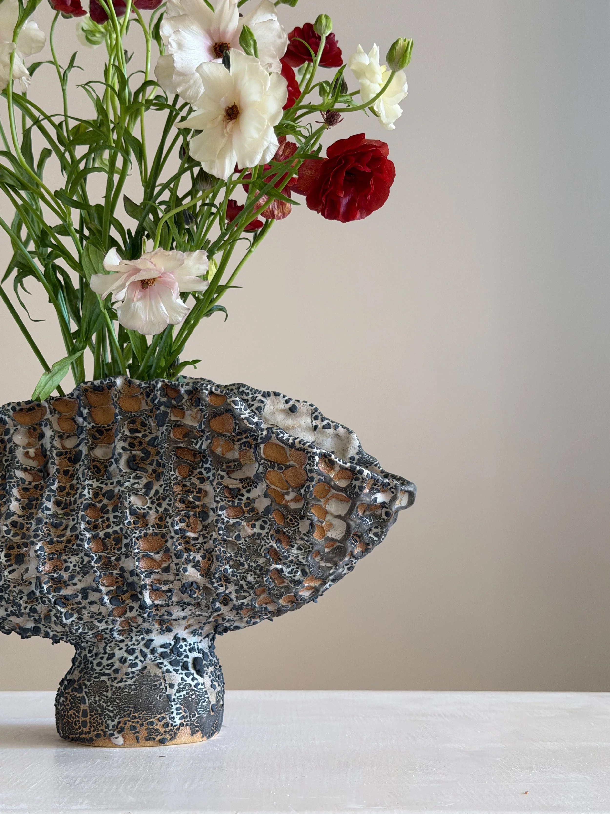 Coral Vase with Black: with a honeycomb, coral-like surface finished in black, a sculptural ceramic vase by Anastasia Babenko