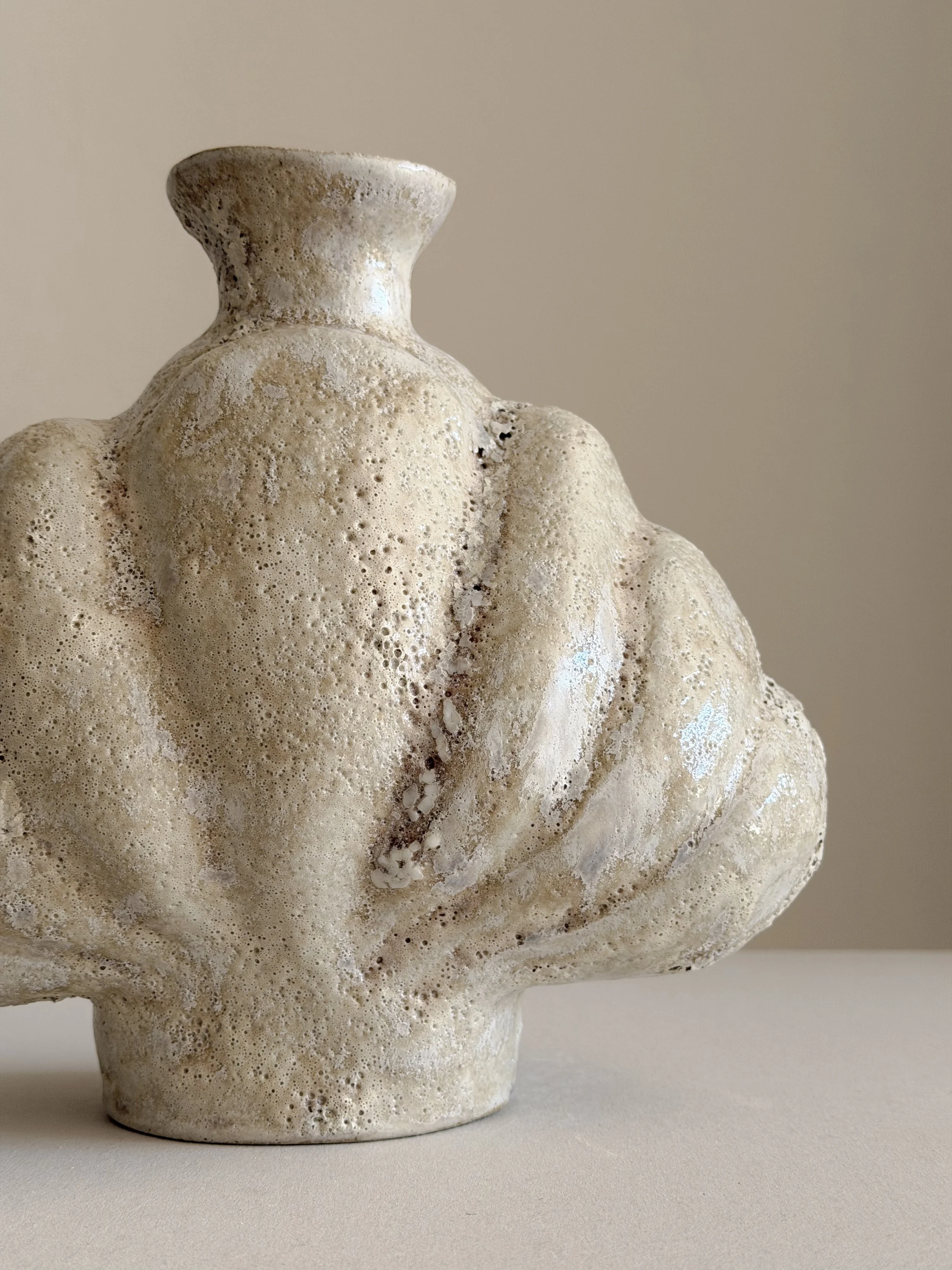 Shell in Beige — hand-built ceramic vase shaped like a deep-sea shell, full and protective, in soft beige stoneware, by Anastasia Babenko