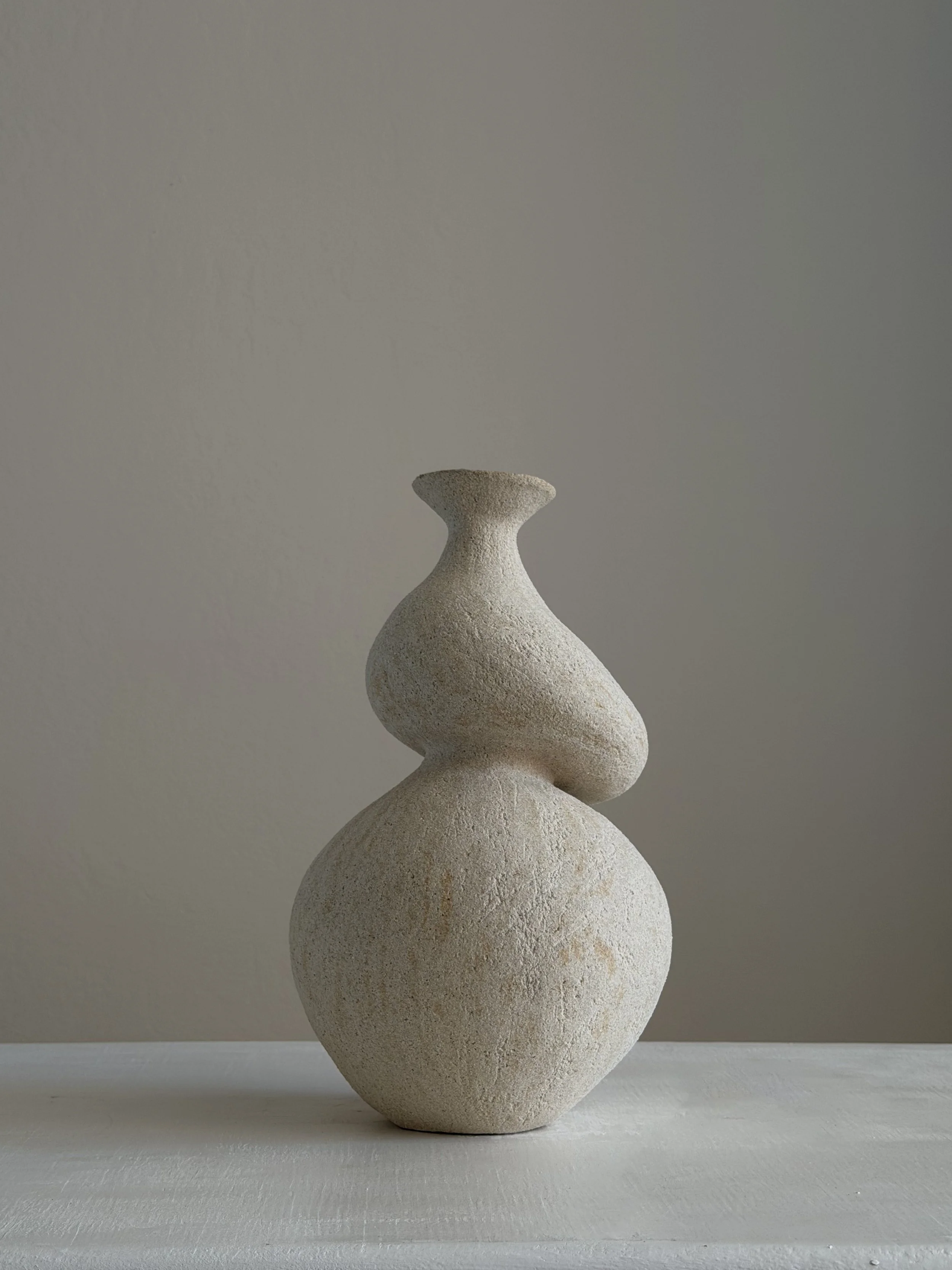 She 5, in the form of a woman caught mid-turn, tilting toward a slender neck — sculptural ceramic vase made for considered, organic interiors