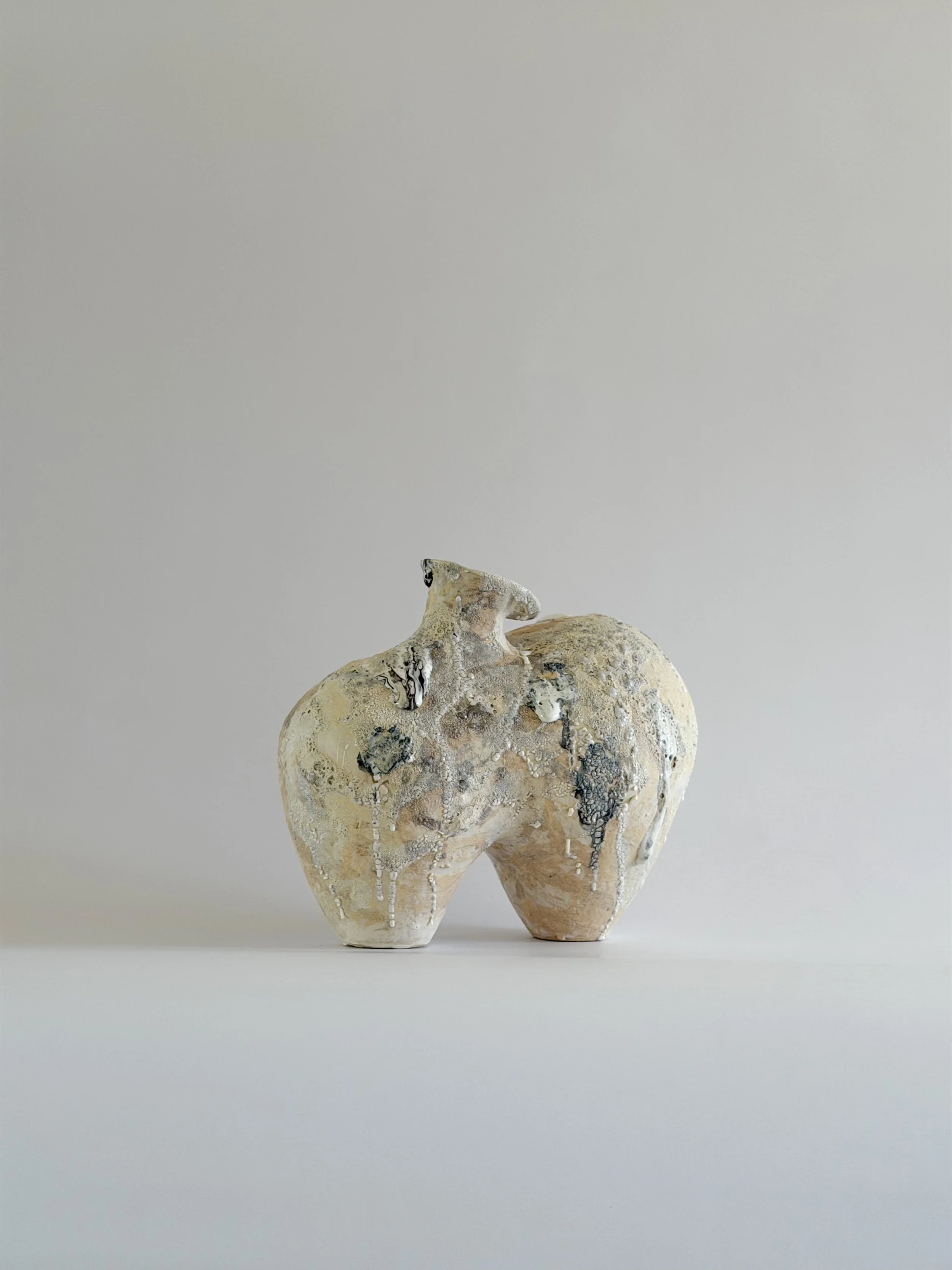 Form No. 1 — hand-built ceramic vase with two full volumes resting under a crawling, sand-colored mineral crust, by Anastasia Babenko
