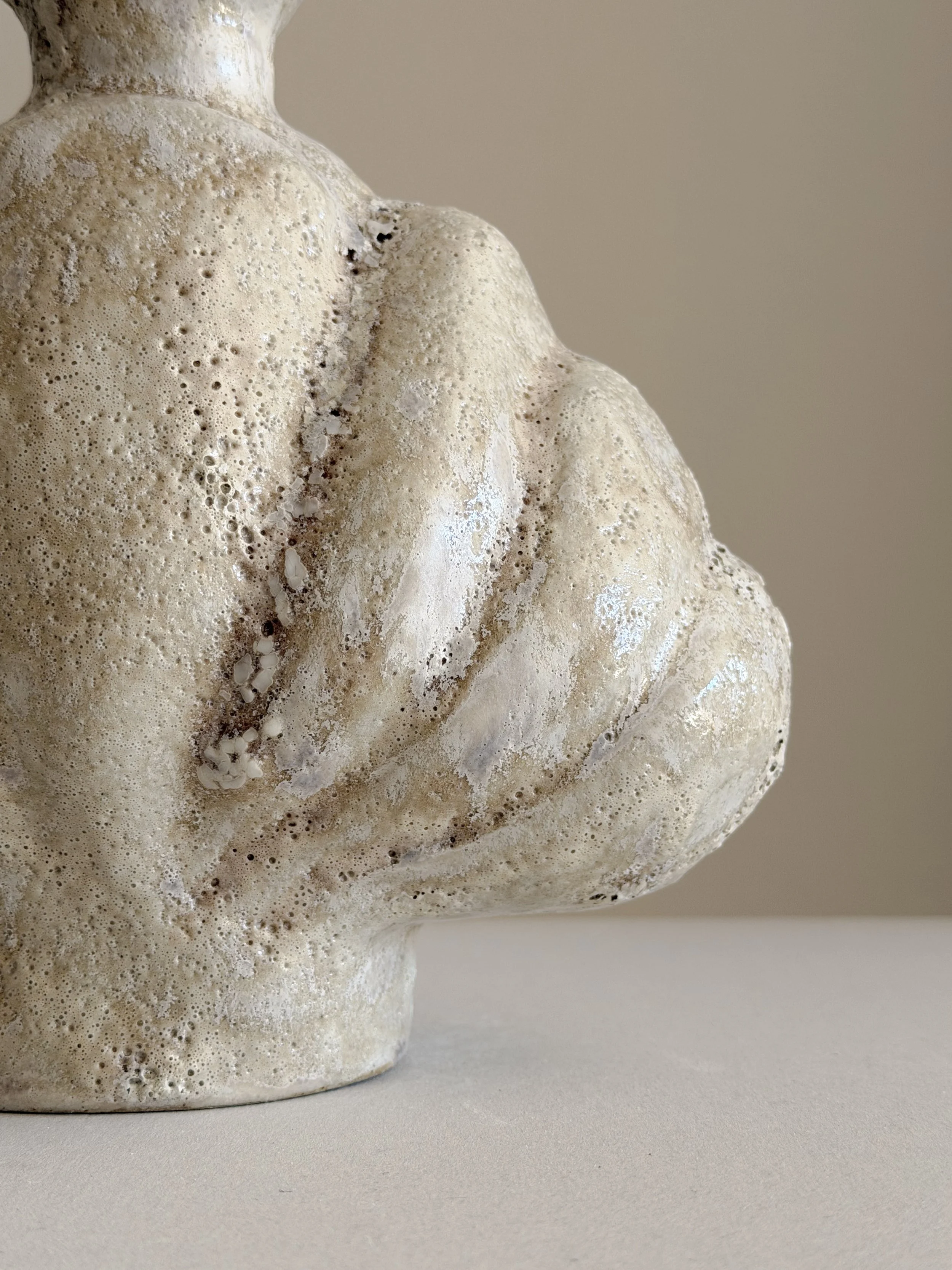 Shell in Beige, shaped like a deep-sea shell, full and protective, in soft beige stoneware — sculptural ceramic vase made for considered,