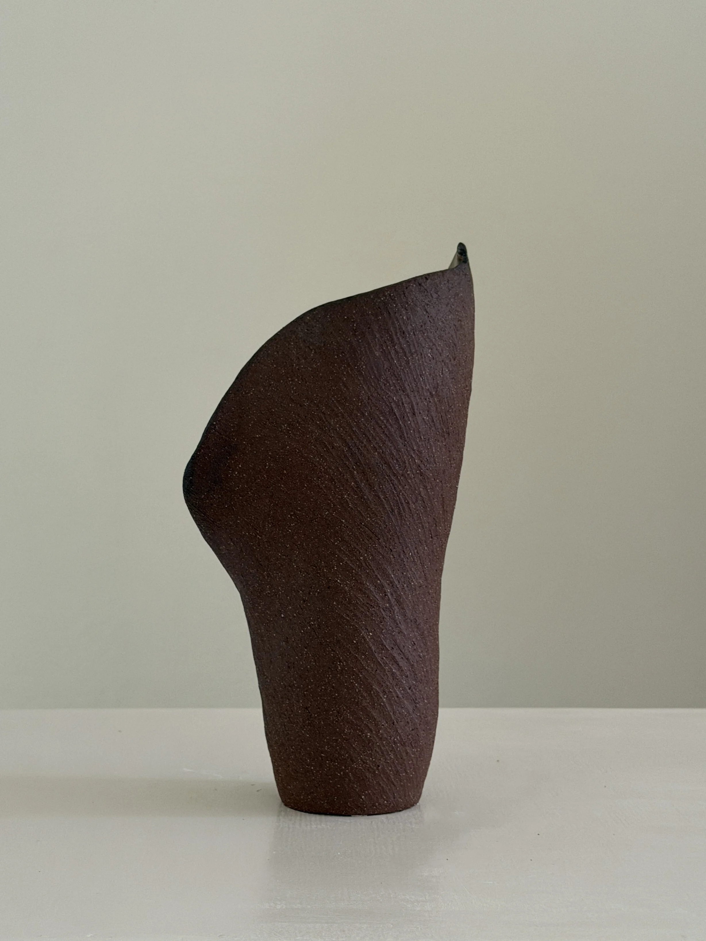 Calla 8 — hand-built ceramic vase drawn from the calla lily, soft and slightly twisted, in beige stoneware, by Anastasia Babenko