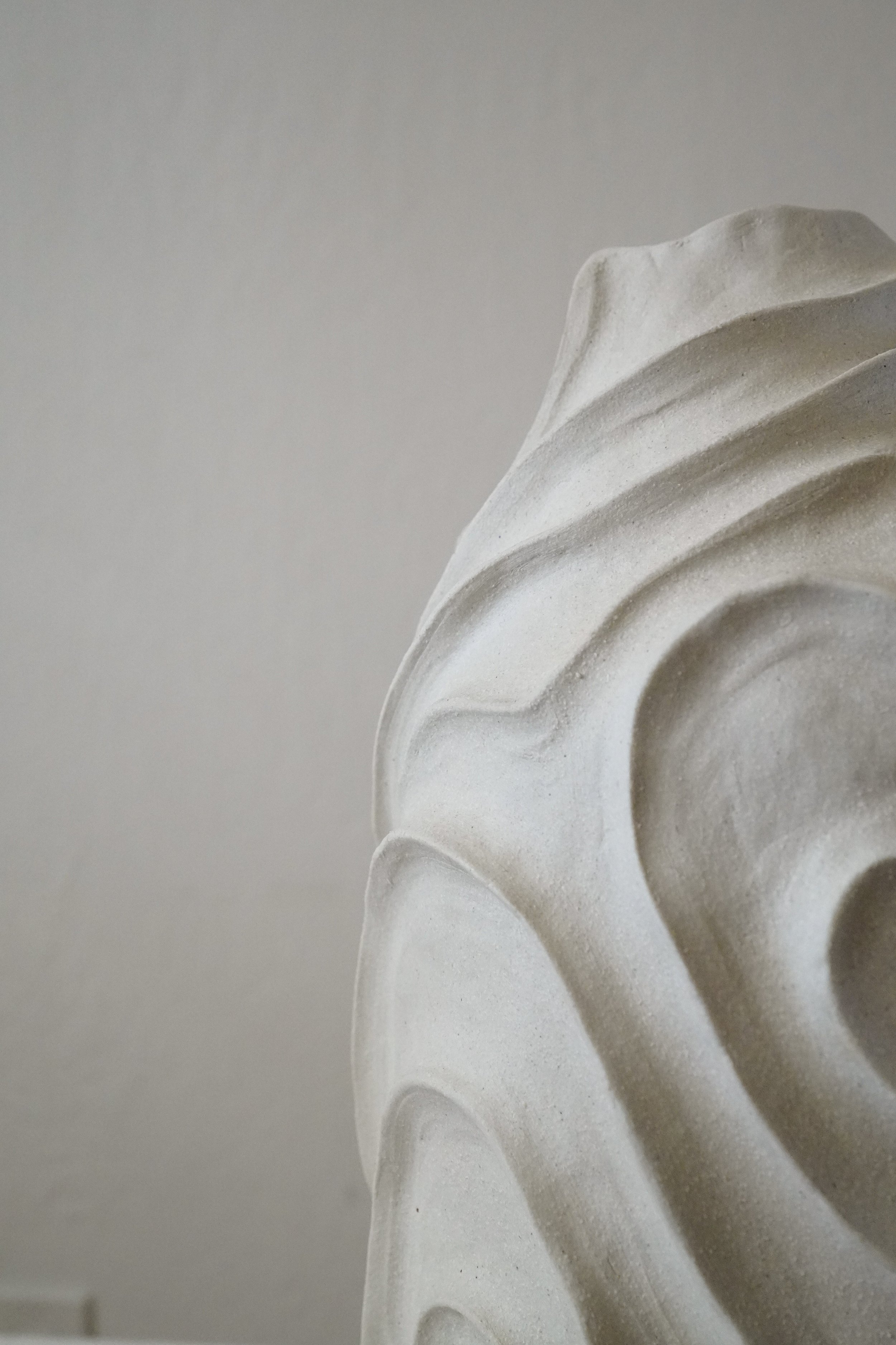 Alabaster No. 1 — hand-built ceramic vase carved all over with flowing, swirling relief in pale matte stoneware, by Anastasia Babenko