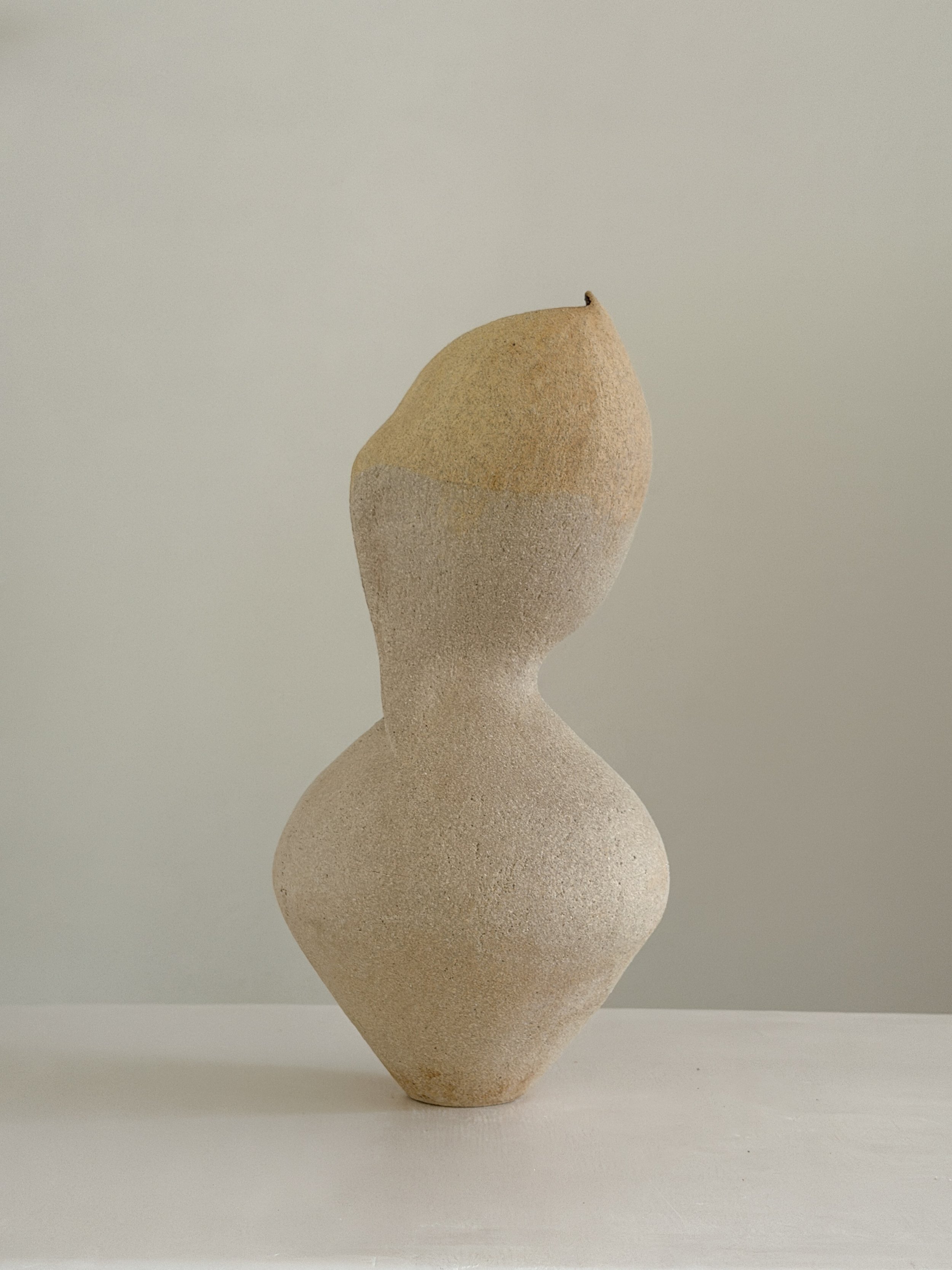 Woman 4, in the form of a woman at rest, soft and full, in warm beige stoneware — sculptural ceramic vase made for considered, organic interiors