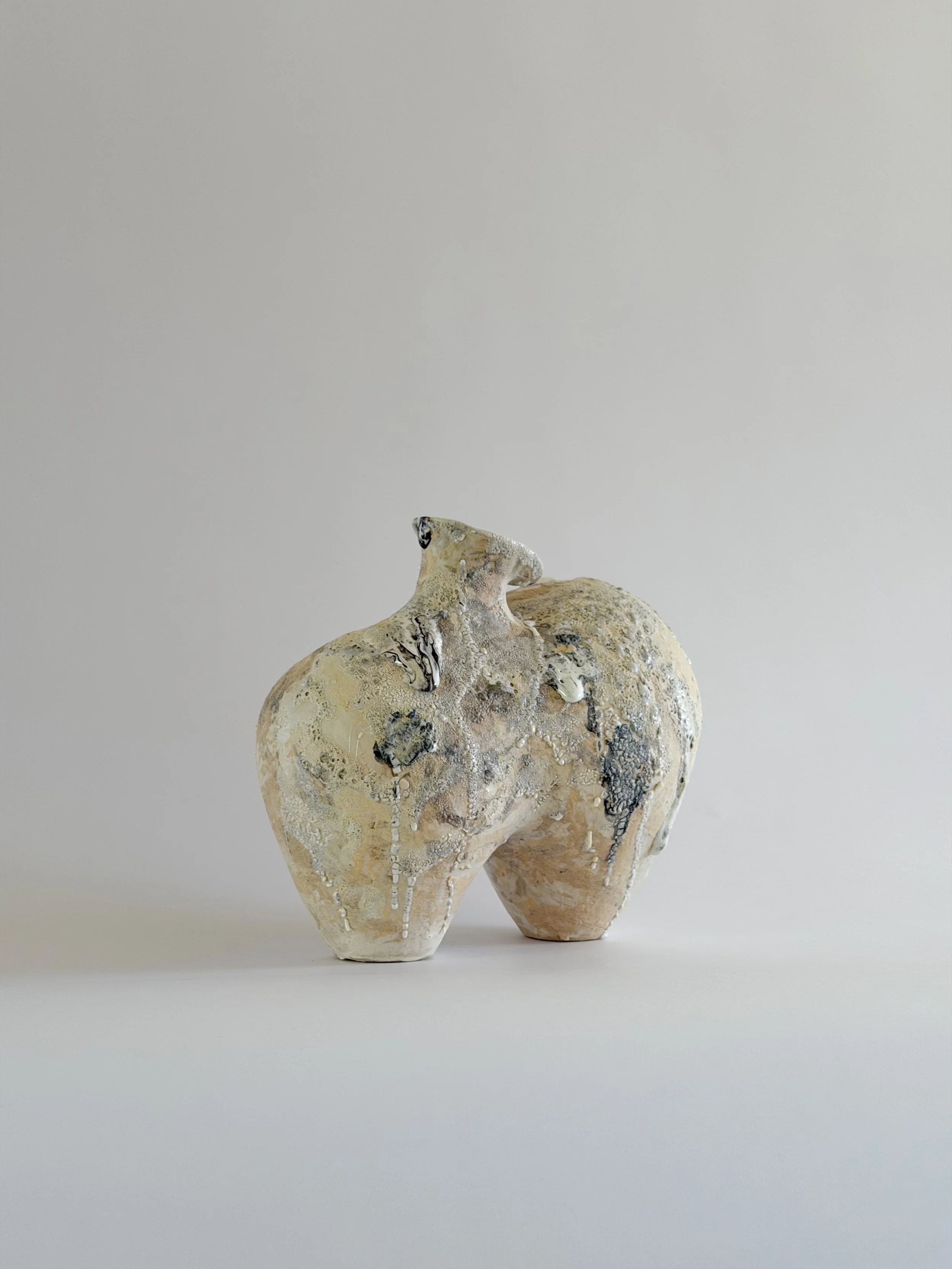 Form No. 1 — hand-built ceramic vase with two full volumes resting under a crawling, sand-colored mineral crust, by Anastasia Babenko