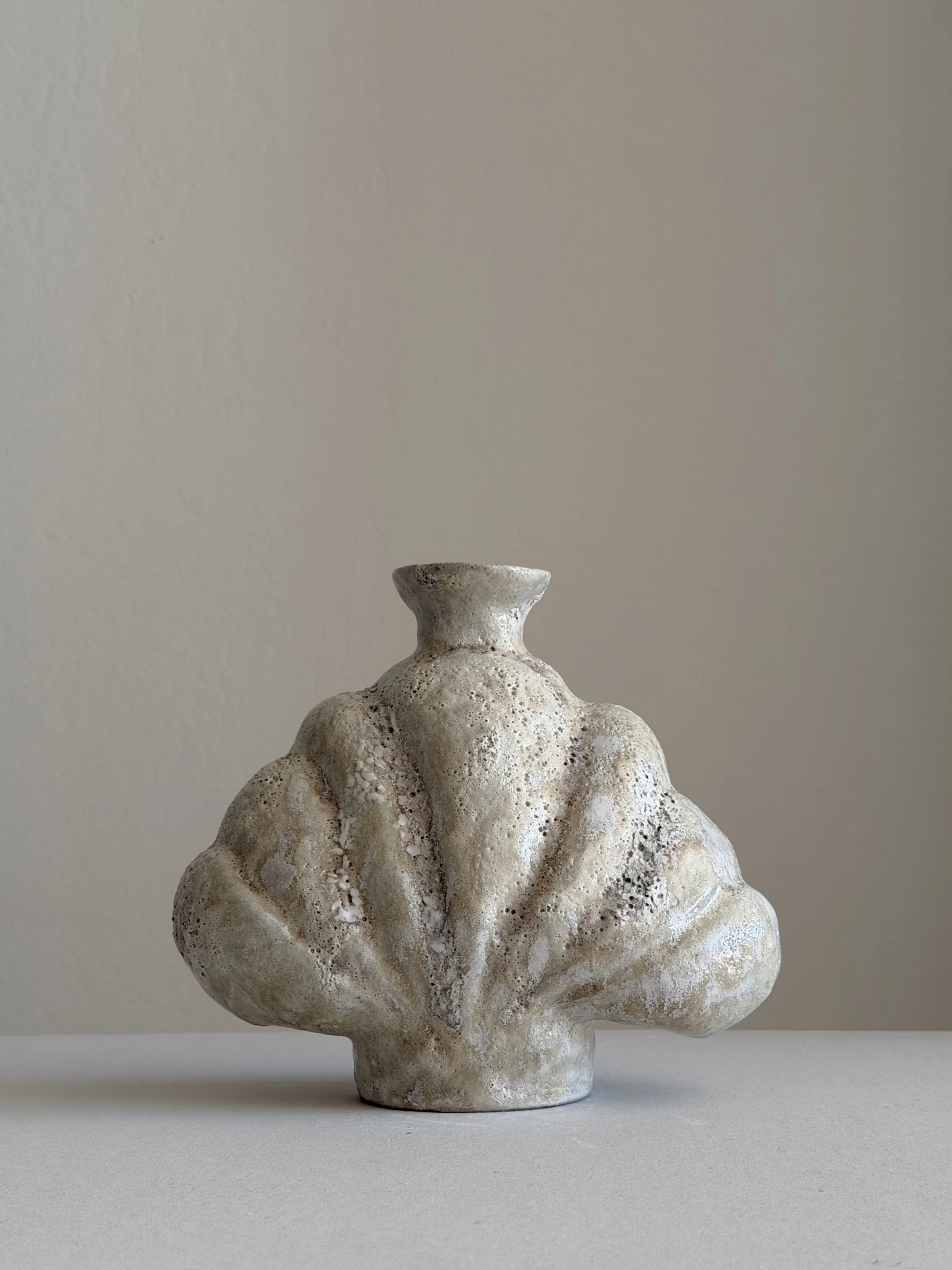Shell in Beige, shaped like a deep-sea shell, full and protective, in soft beige stoneware — sculptural ceramic vase sculptural decor for
