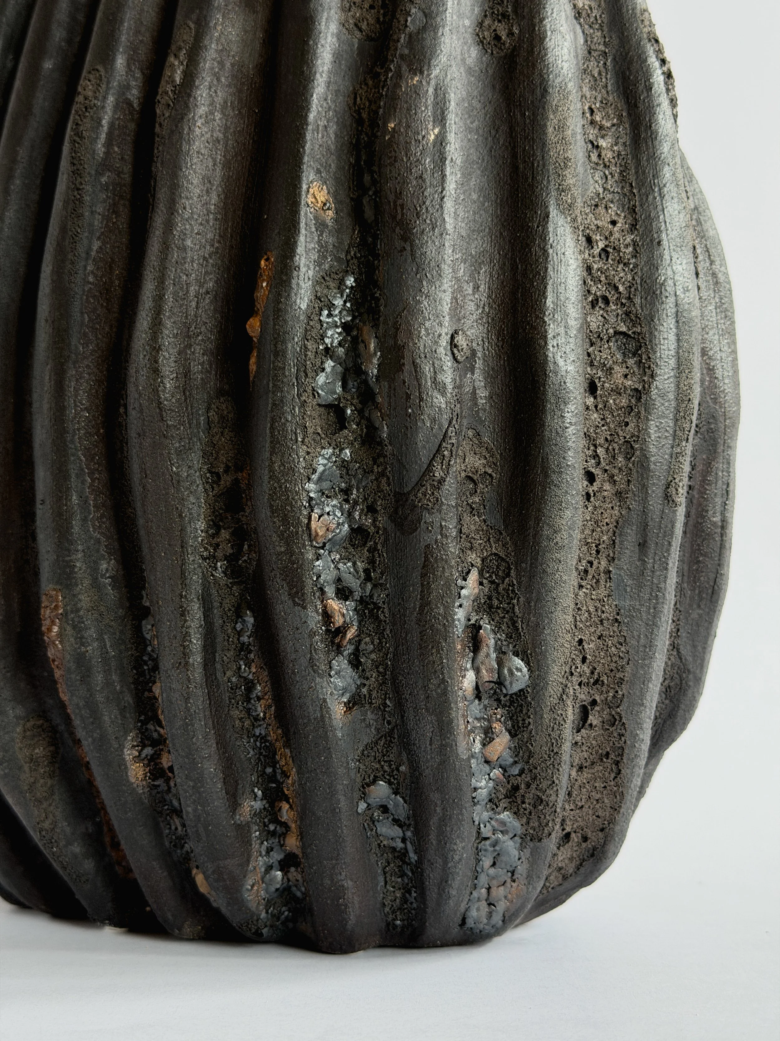 Hand-built ceramic vase: Large Black Shell Vase, shaped like a large deep-sea shell with heavy scalloped ridges in dark stoneware — Anastasia