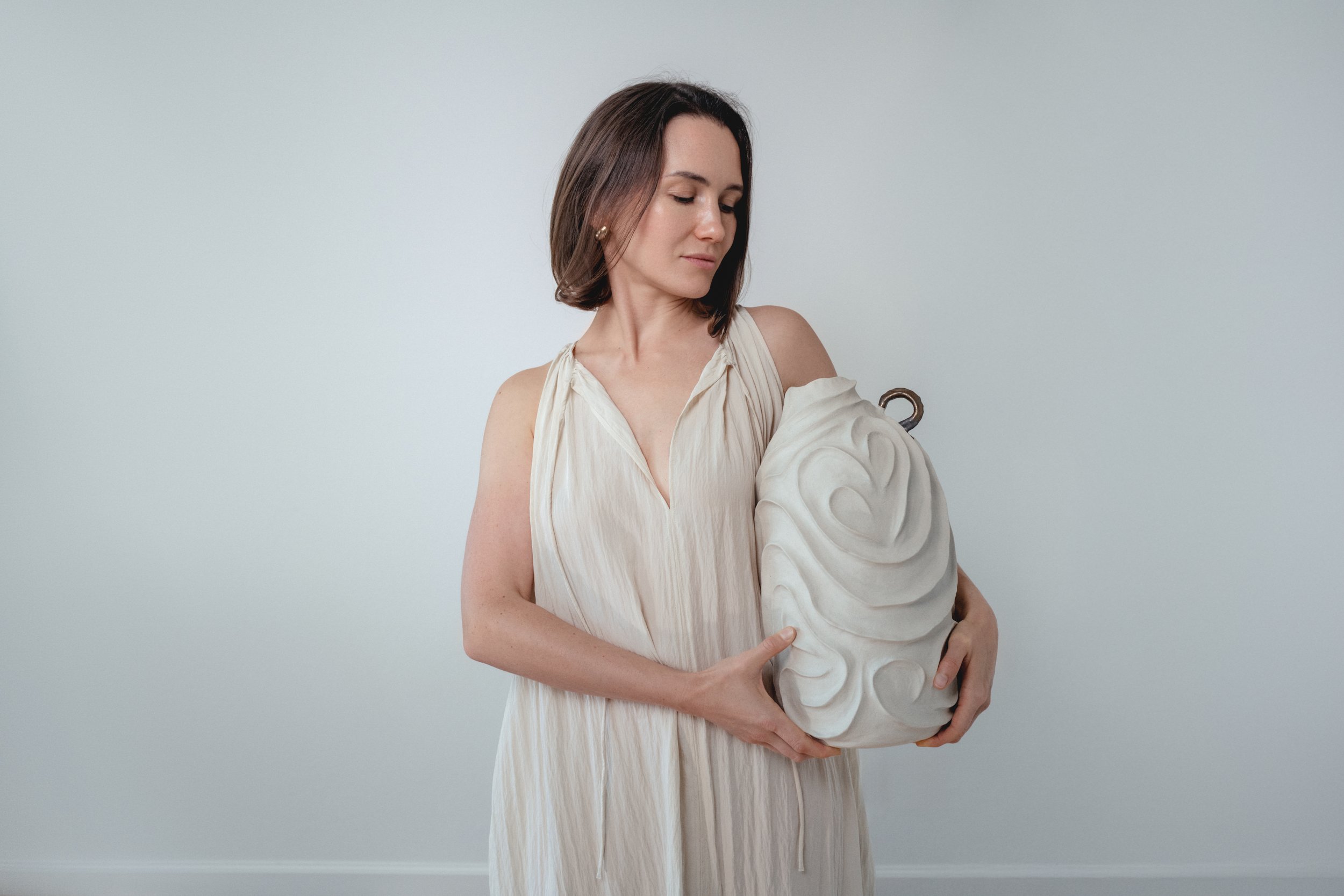Alabaster No. 1 by Anastasia Babenko — carved all over with flowing, swirling relief in pale matte stoneware, sculptural decor for design-led