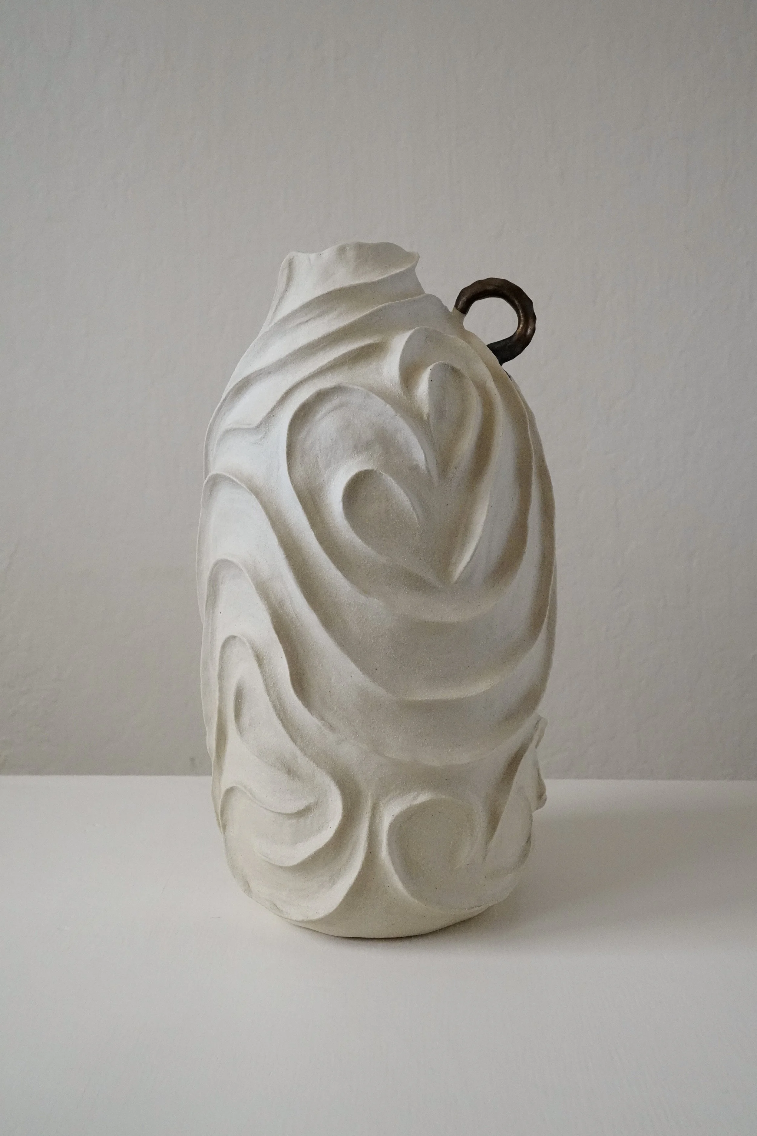 Alabaster No. 1, carved all over with flowing, swirling relief in pale matte stoneware — sculptural ceramic vase made for considered, organic