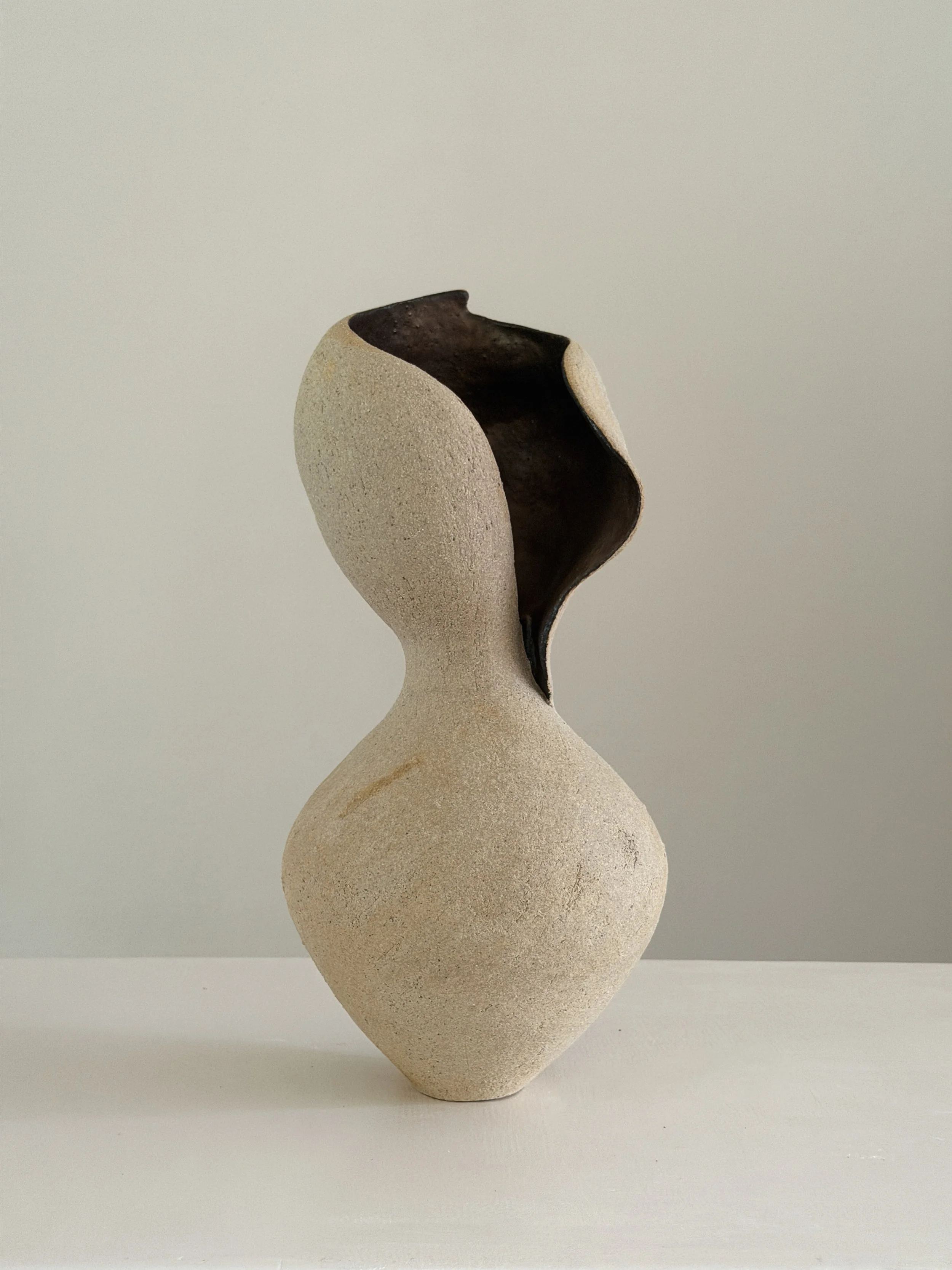 Woman 4 — hand-built ceramic vase in the form of a woman at rest, soft and full, in warm beige stoneware, by Anastasia Babenko