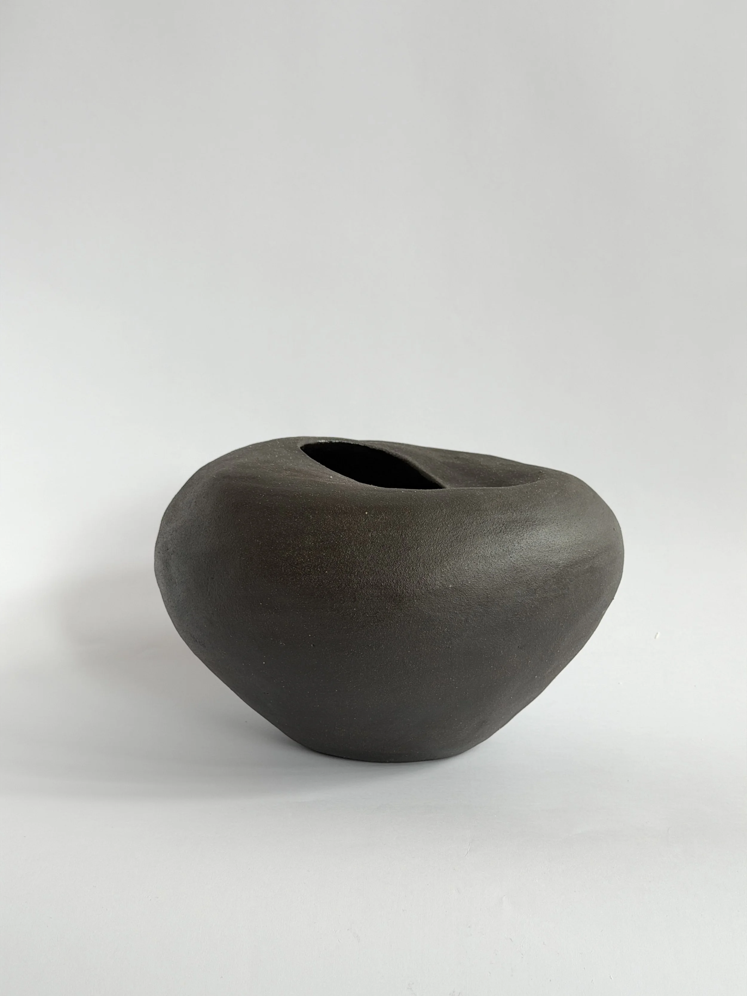 Whispering Stone by Anastasia Babenko — shaped like a smooth river stone, organic and calming, original ceramic art for interior designers