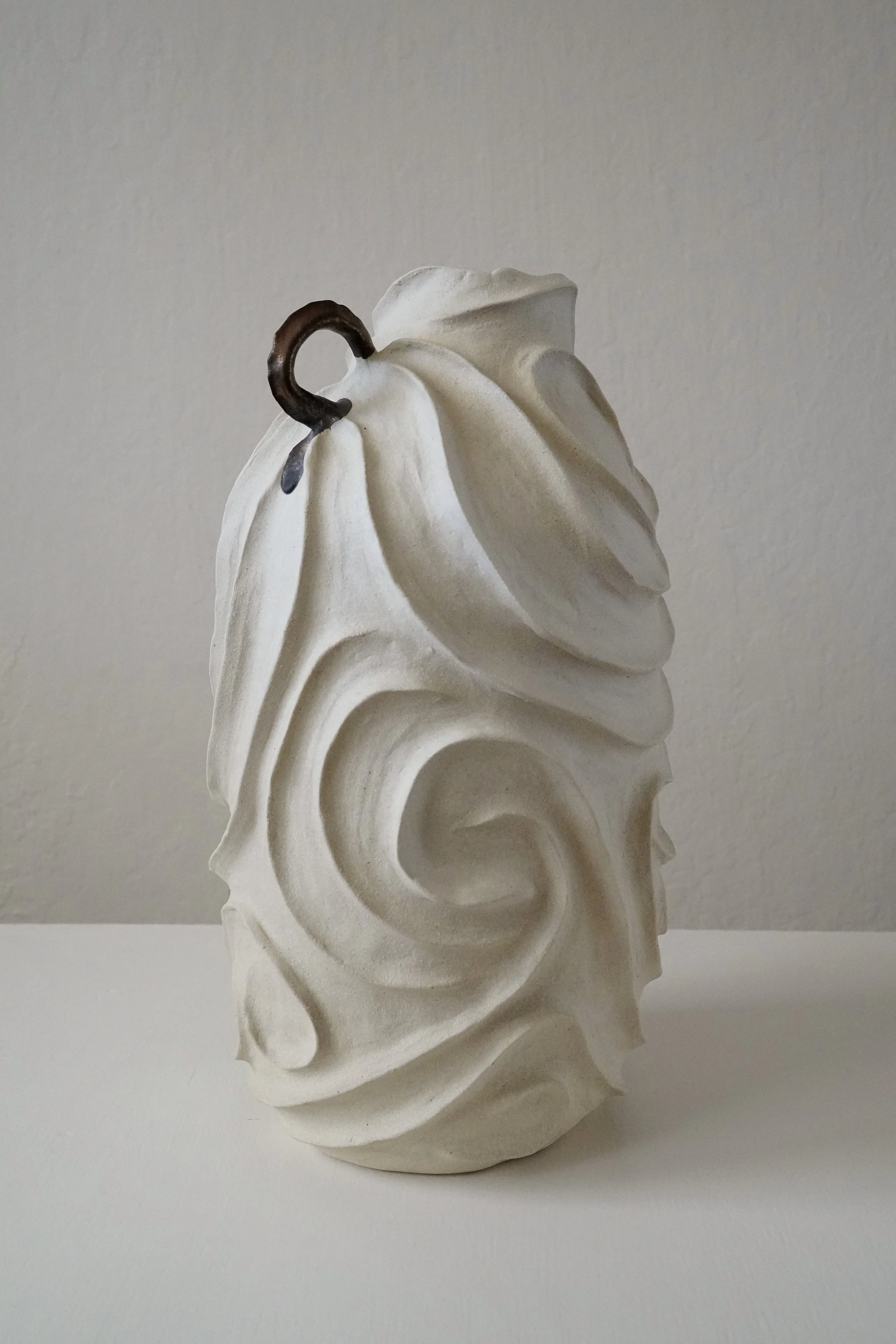 Alabaster No. 1, carved all over with flowing, swirling relief in pale matte stoneware — sculptural ceramic vase sculptural decor for