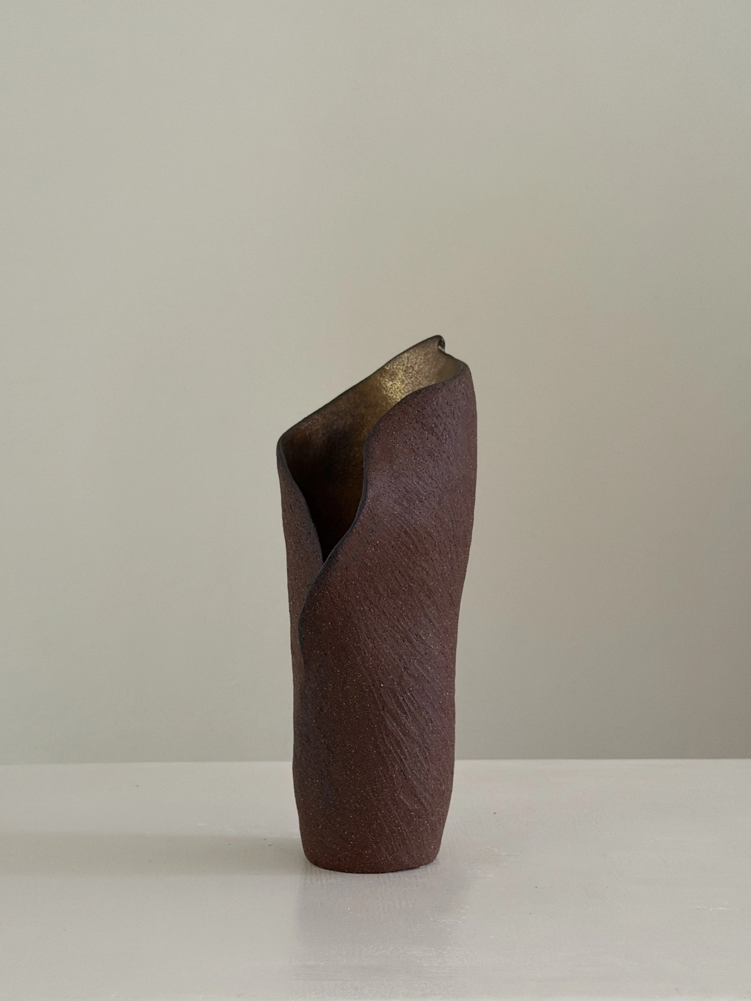 Calla 8: drawn from the calla lily, soft and slightly twisted, in beige stoneware, a sculptural ceramic vase by Anastasia Babenko