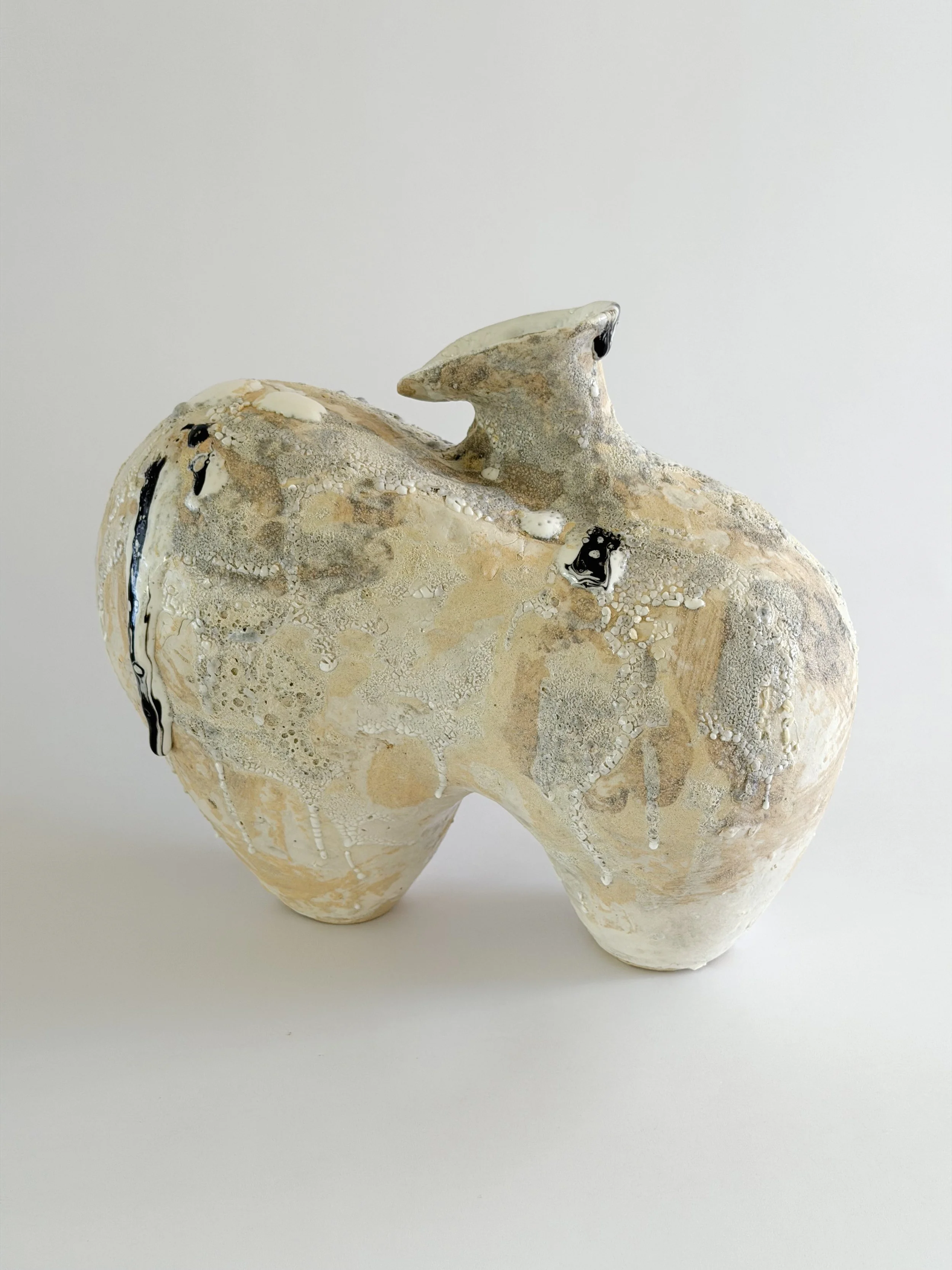 Form No. 1: with two full volumes resting under a crawling, sand-colored mineral crust, a sculptural ceramic vase by Anastasia Babenko
