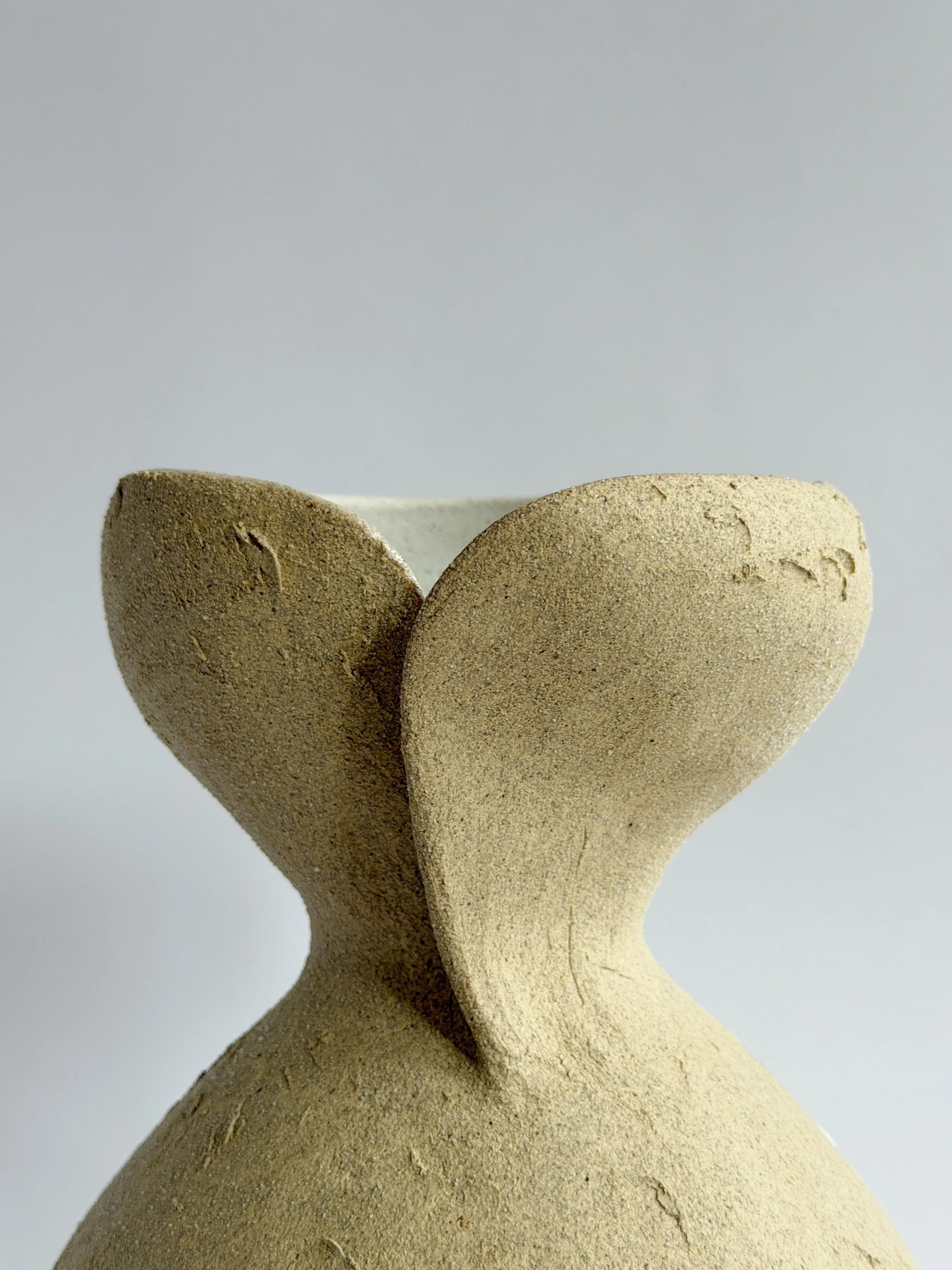 Hand-built ceramic vase: Silhouette Vase in Beige, tracing a woman's full, rounded silhouette in beige stoneware — Anastasia Babenko
