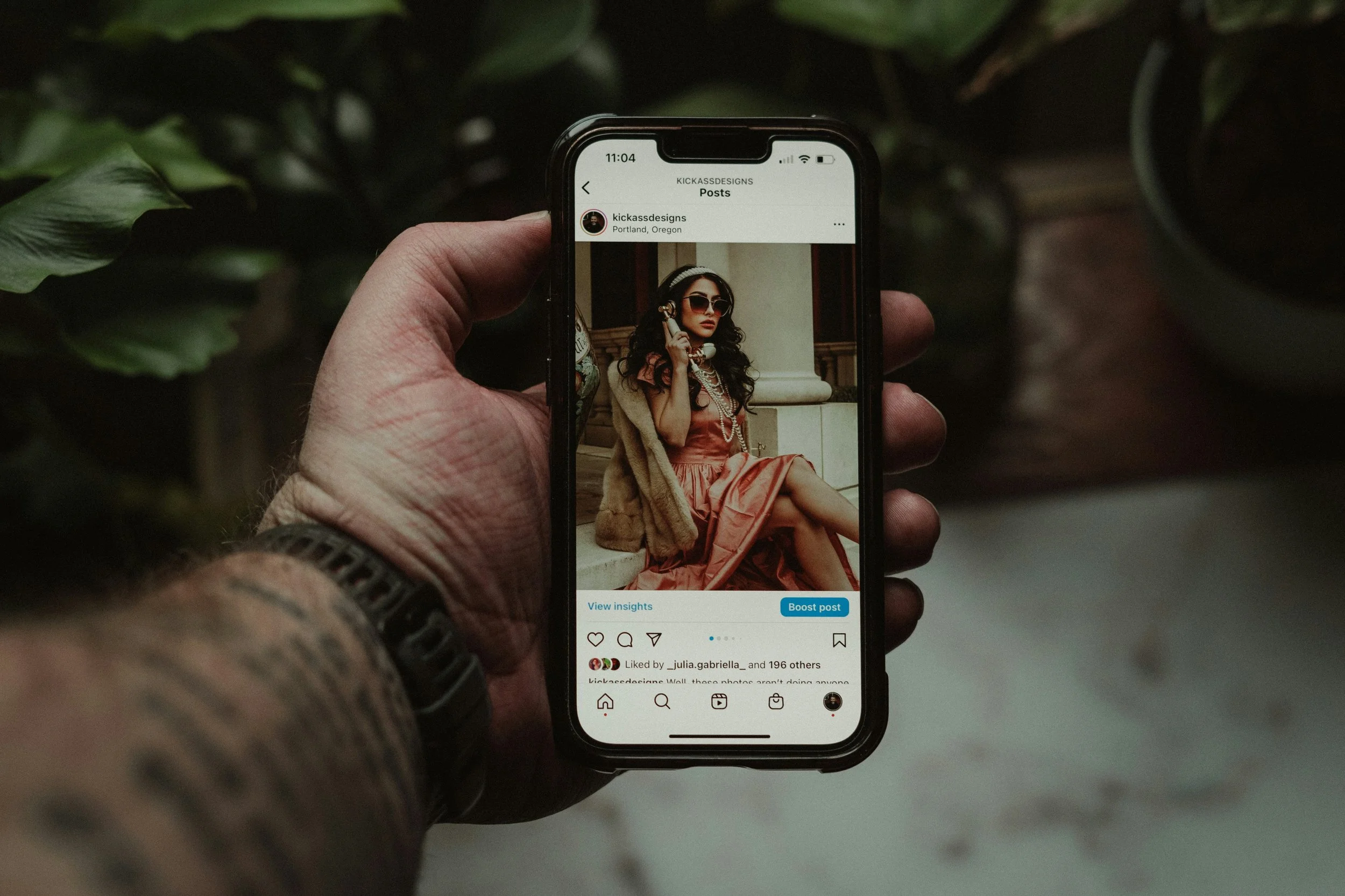 Man scrolling Instagram on his phone, illustrating how social media shapes betrayal and monogamy today