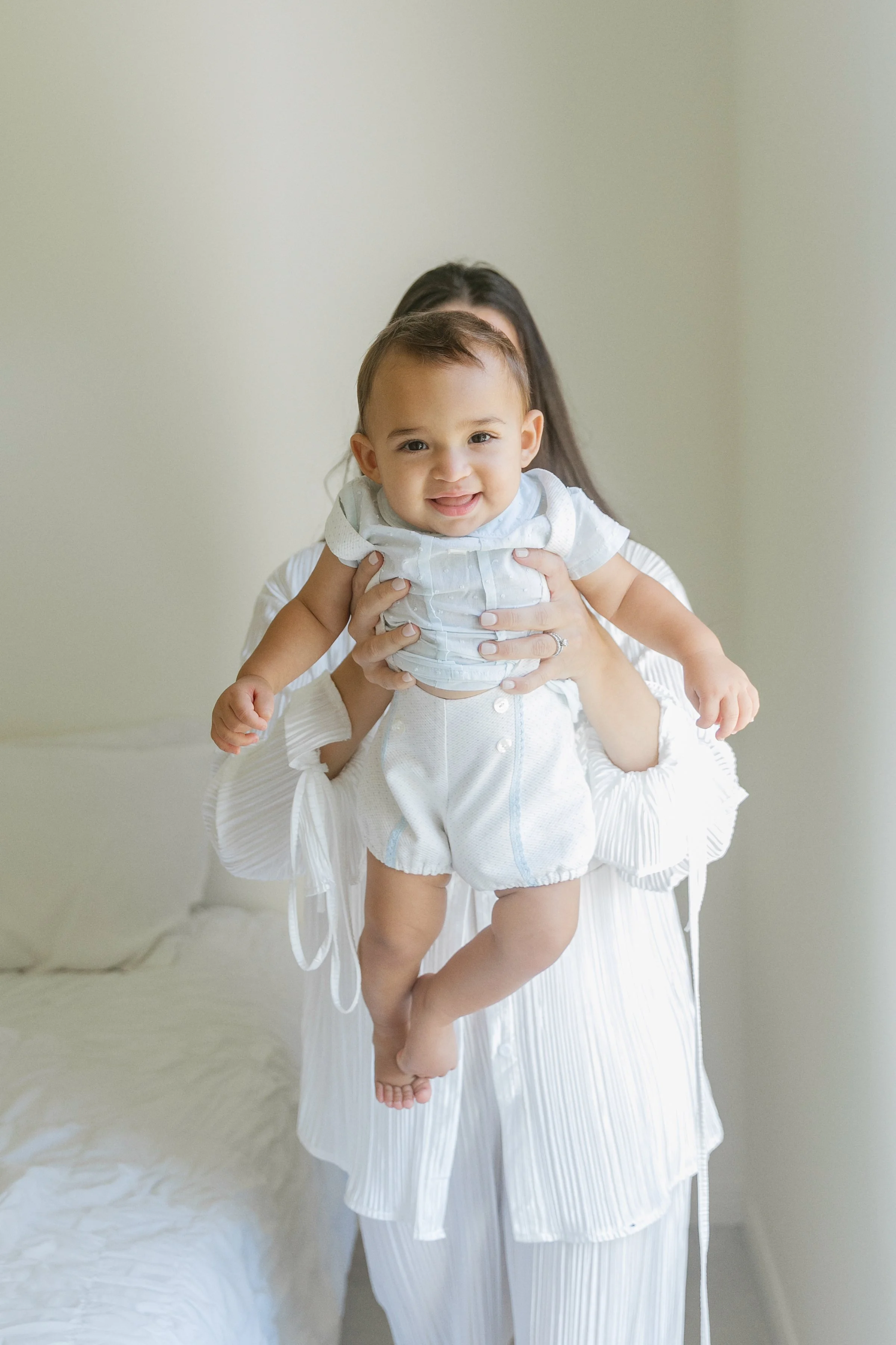 Elegant motherhood portrait of mother holding baby in Houston TX