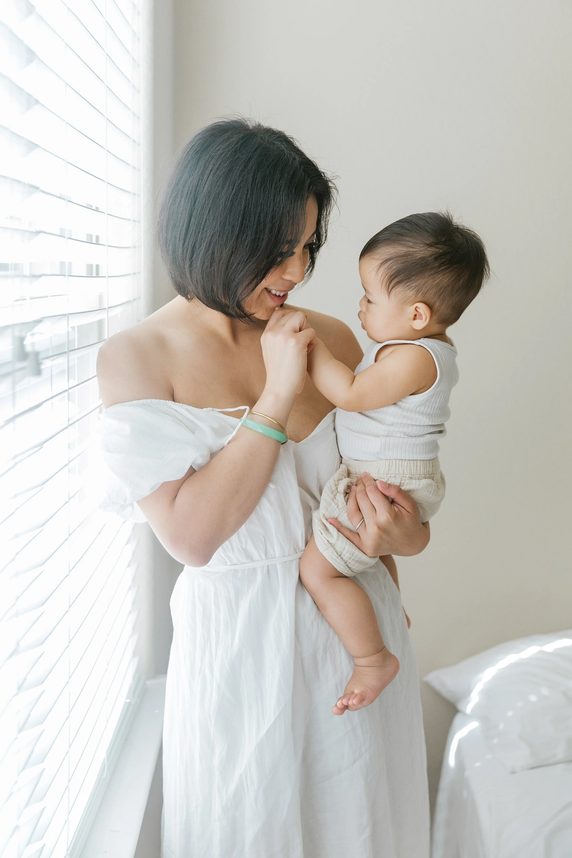Mother holding her child during natural light mommy and me photography session in Houston
