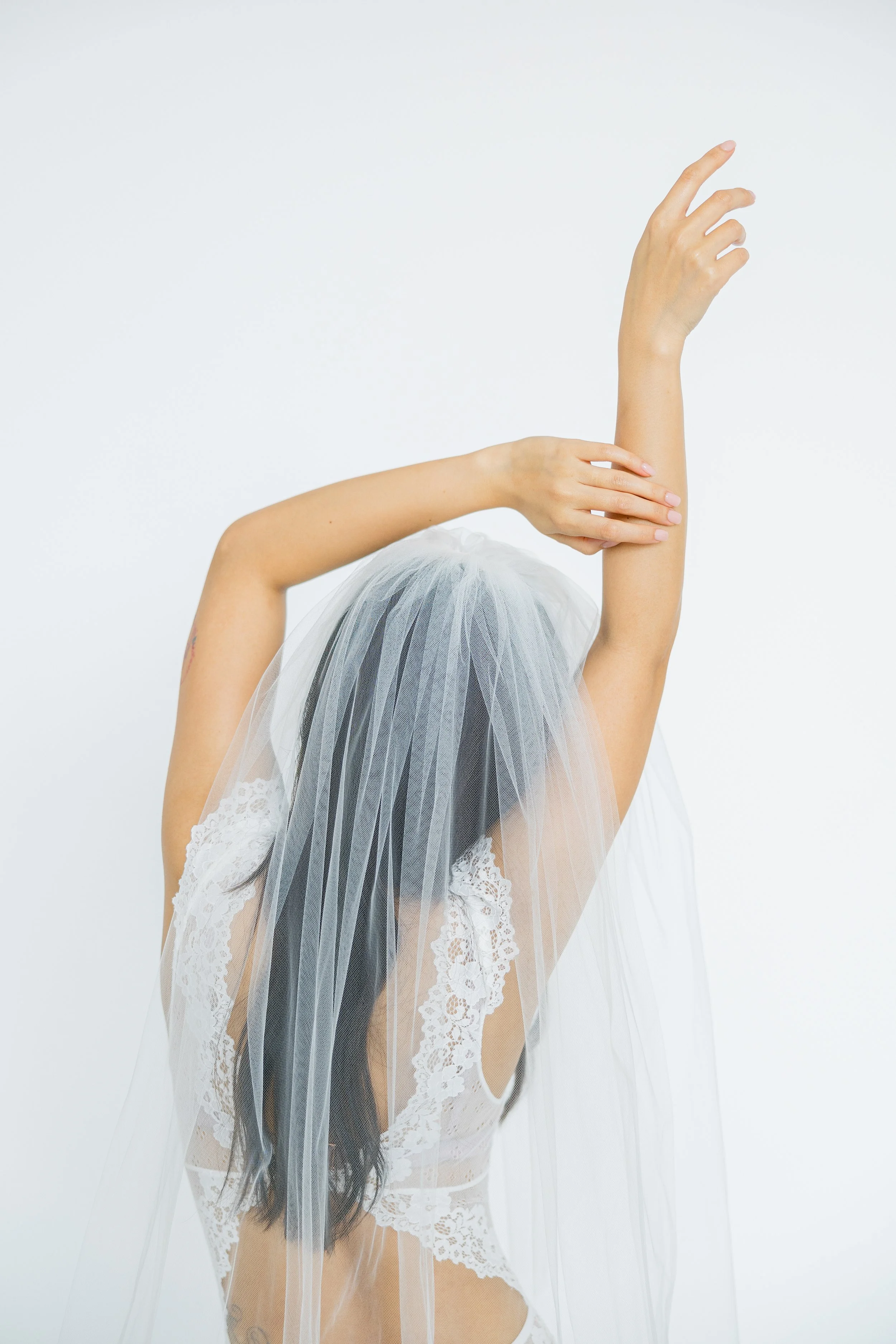 Intimate boudoir portrait of woman posing in natural light studio in Houston