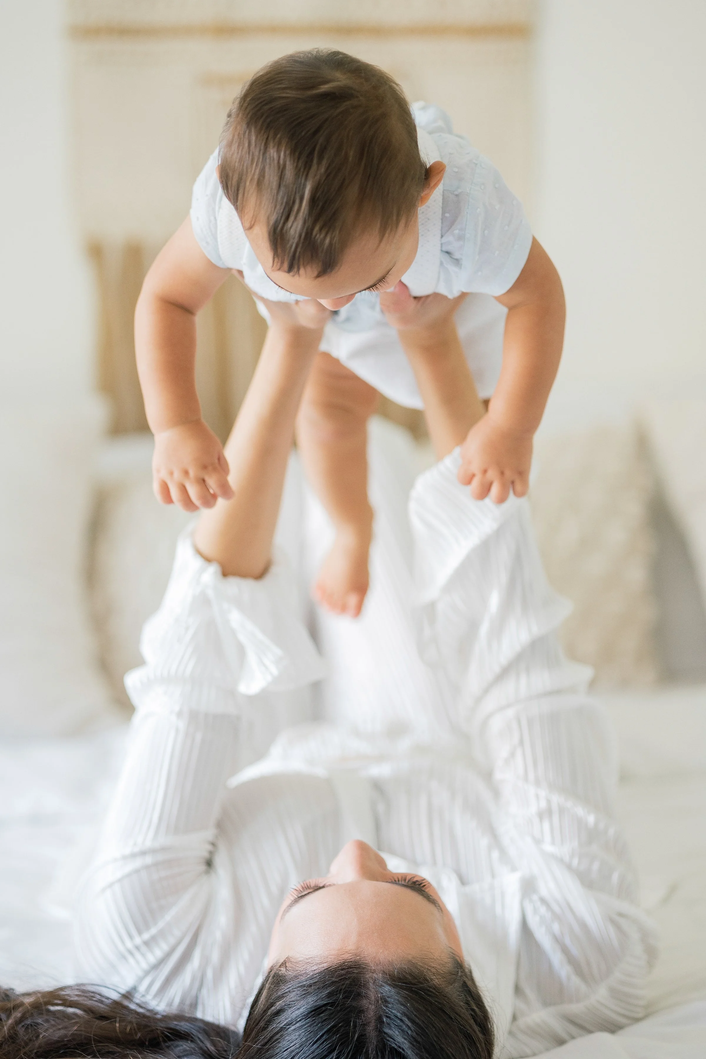 Mother lifting her child in joyful motherhood portrait session in Houston